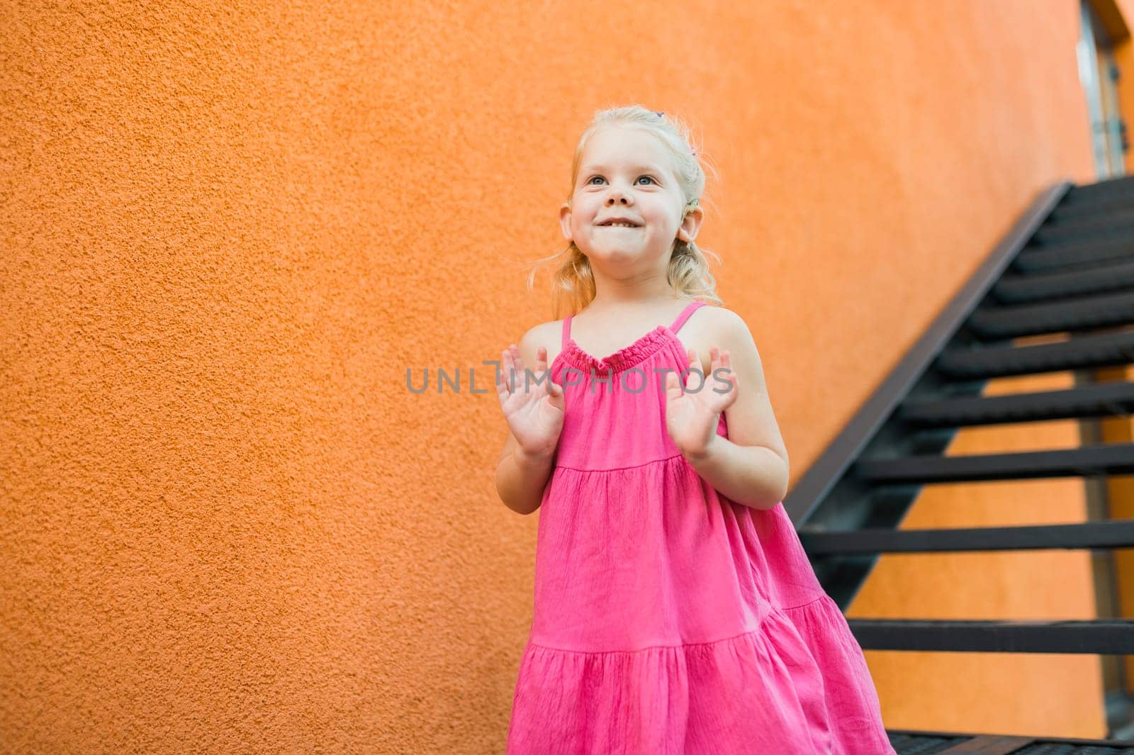 Child walks with cochlear implant system. Installation cochlear implant on child girl ear for restores hearing. Kid hears after hear return to normal. Diversity inclusion