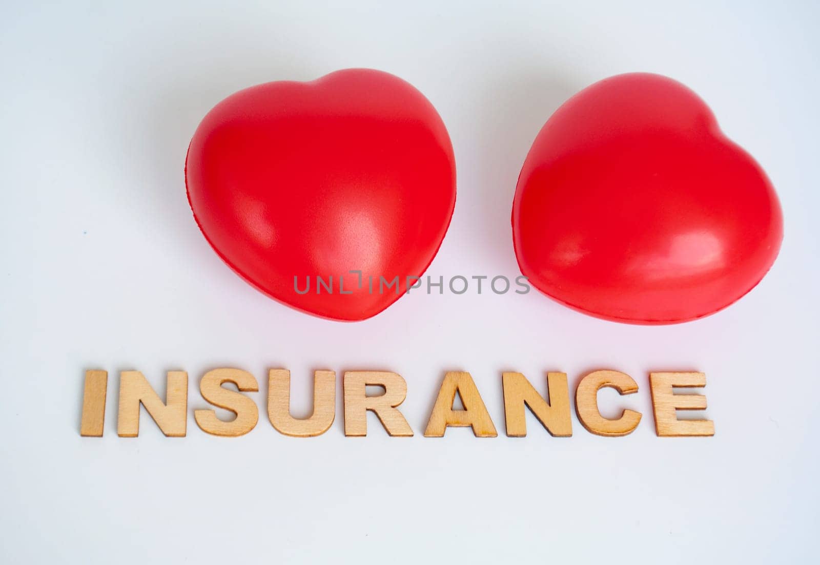 Heart shapes with insurance text on white background. Life insurance concept.