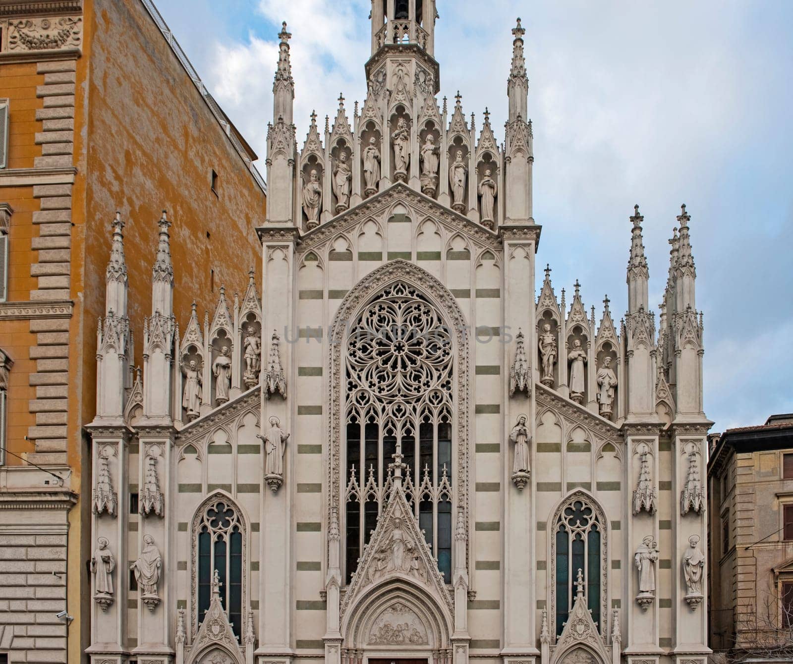 Ornate facade exterior of catholic church in city centre by paulvinten