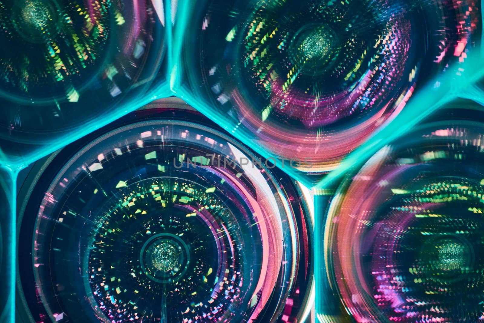 Vibrant kaleidoscopic patterns refracting through cylindrical glass lenses, creating an abstract art form in Fort Wayne, Indiana