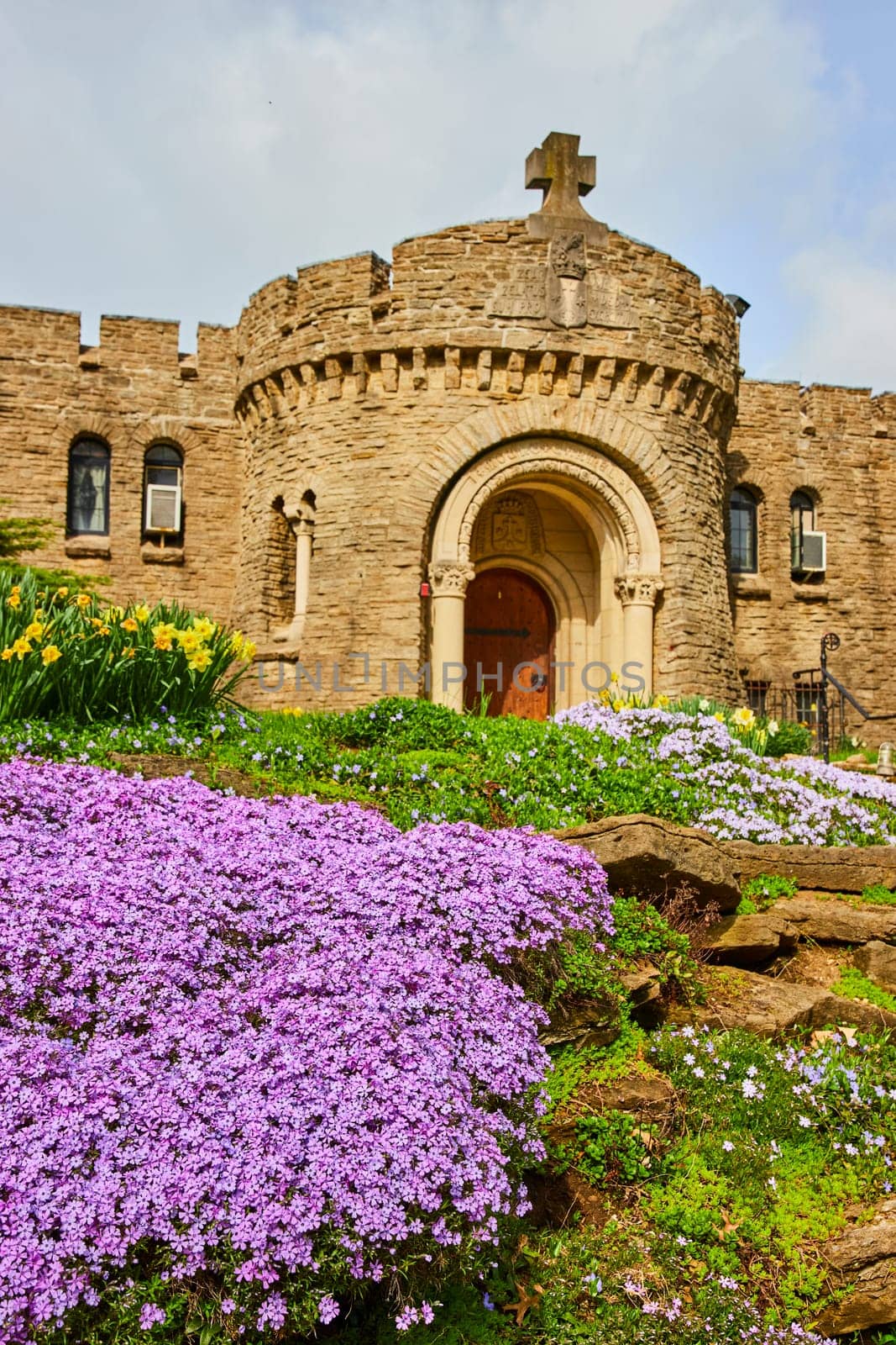 Spring blossoms adorn historical Bishop Simon Brute College Castle in Indianapolis, a symbol of religious heritage and architectural grandeur.
