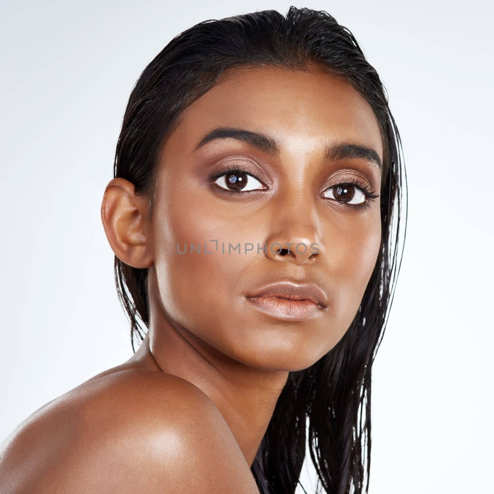 Studio, beauty and portrait of Indian woman with makeup and skincare in mockup space. Face, dermatology and girl with confidence from healthy facial or pride from cosmetics in white background.