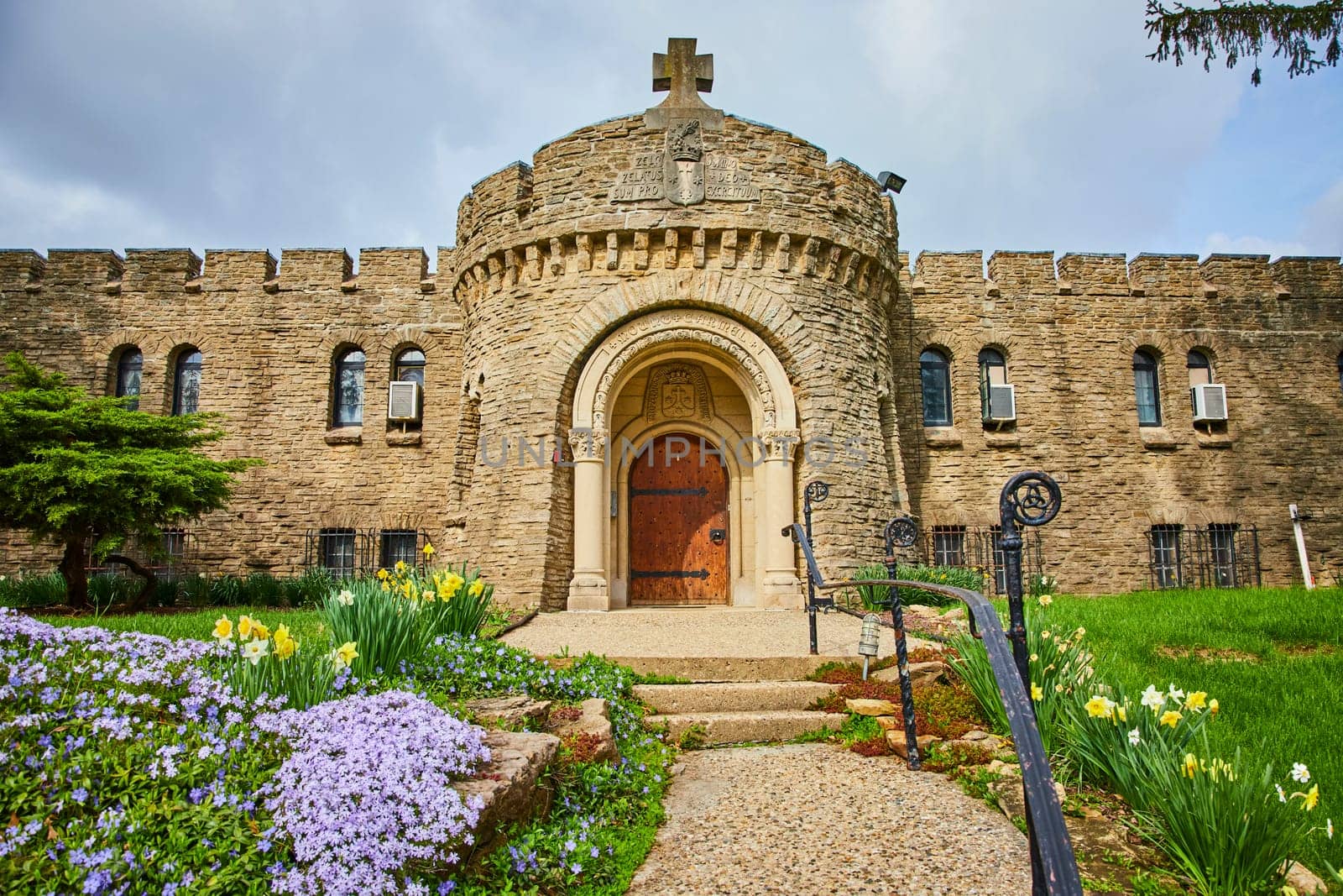 Spring blooms at the striking Bishop Simon Brute College in Indianapolis, showcasing its medieval-style architecture and Christian heritage