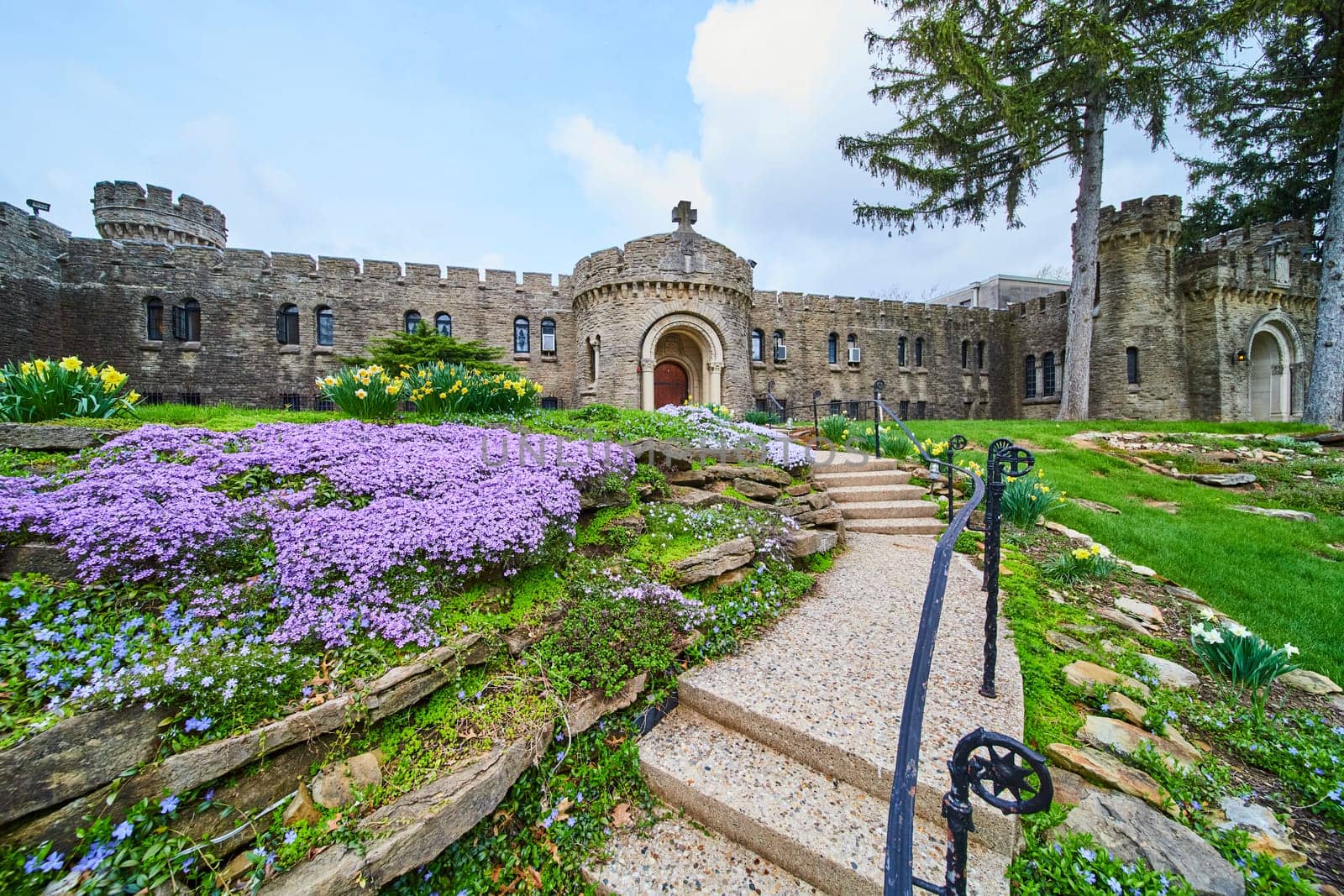 Medieval-inspired Bishop Simon Brute College, set in vibrant spring bloom, exuding Indiana heritage and religious tranquillity.