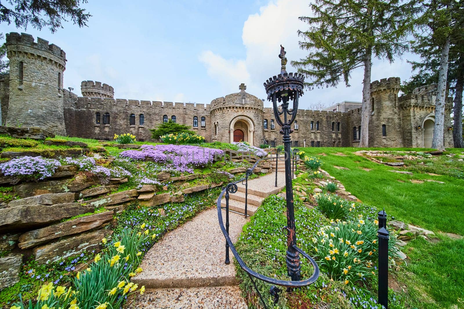 Springtime at Bishop Simon Brute College, showcasing the mix of medieval and modern architecture in a castle, amid vibrant gardens.