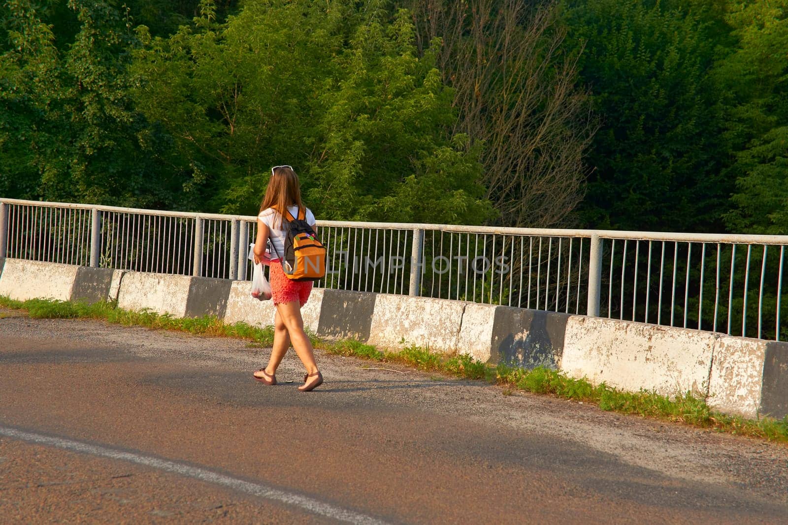 Young cute female traveler with backpack.Woman in red shorts by jovani68