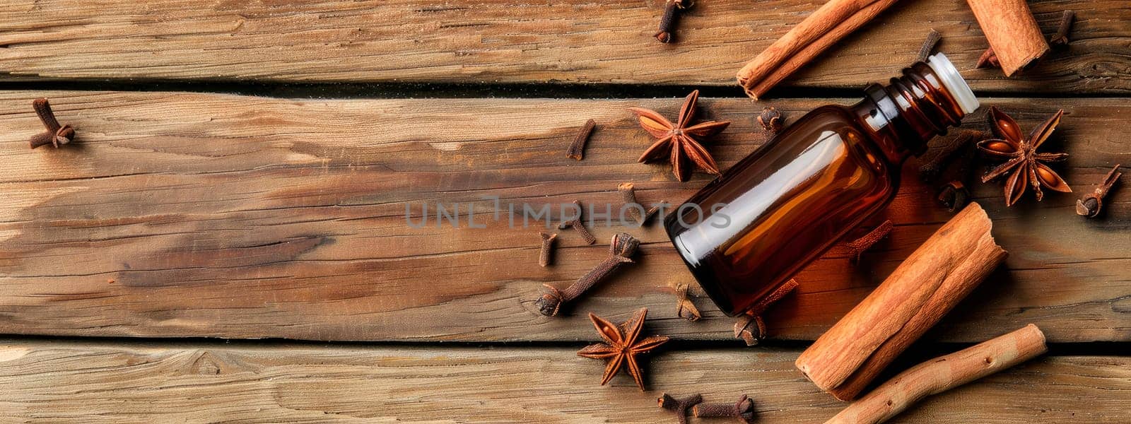 essential oil in a bottle and cinnamon. selective focus. by yanadjana