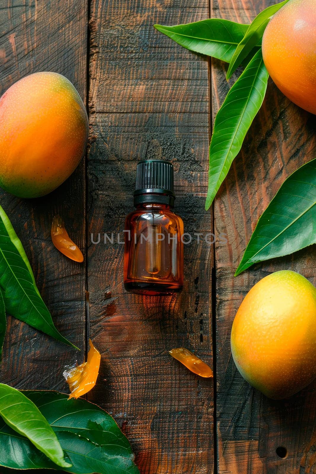 mango essential oil in a bottle. selective focus. by yanadjana