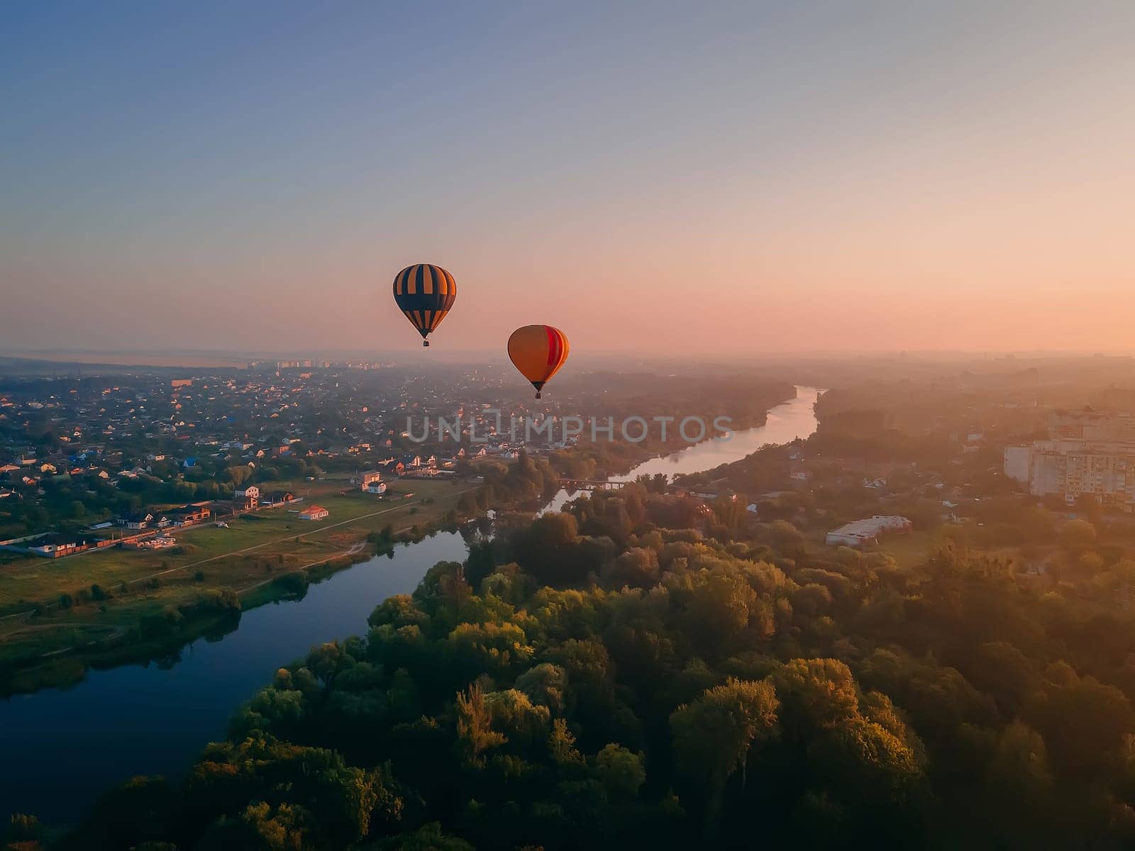 Aerial view of beautiful river and forest landscape with colorful summer sky. Sunset along the banks of the river.