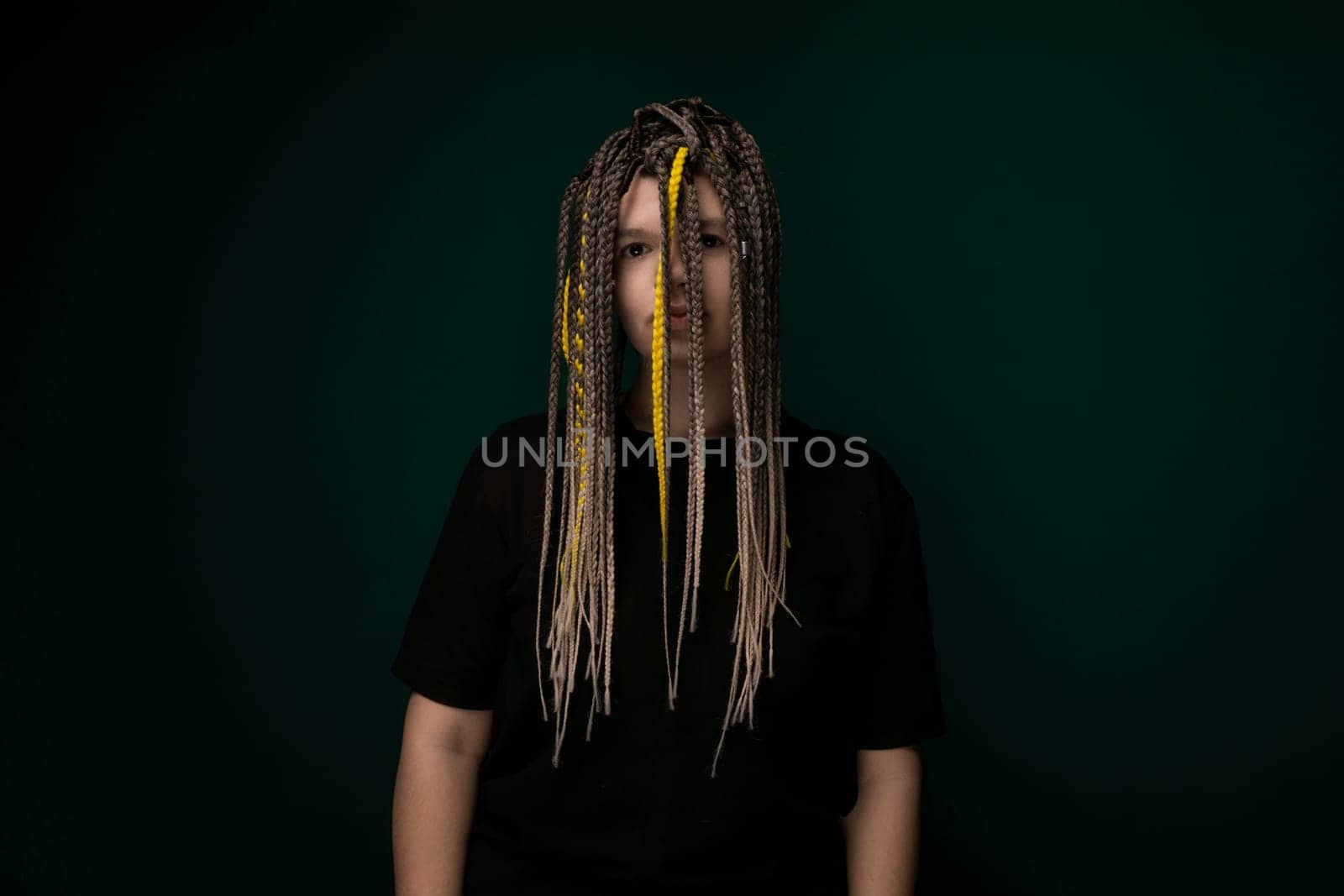 Man With Dreadlocks Standing in Front of Green Background by TRMK