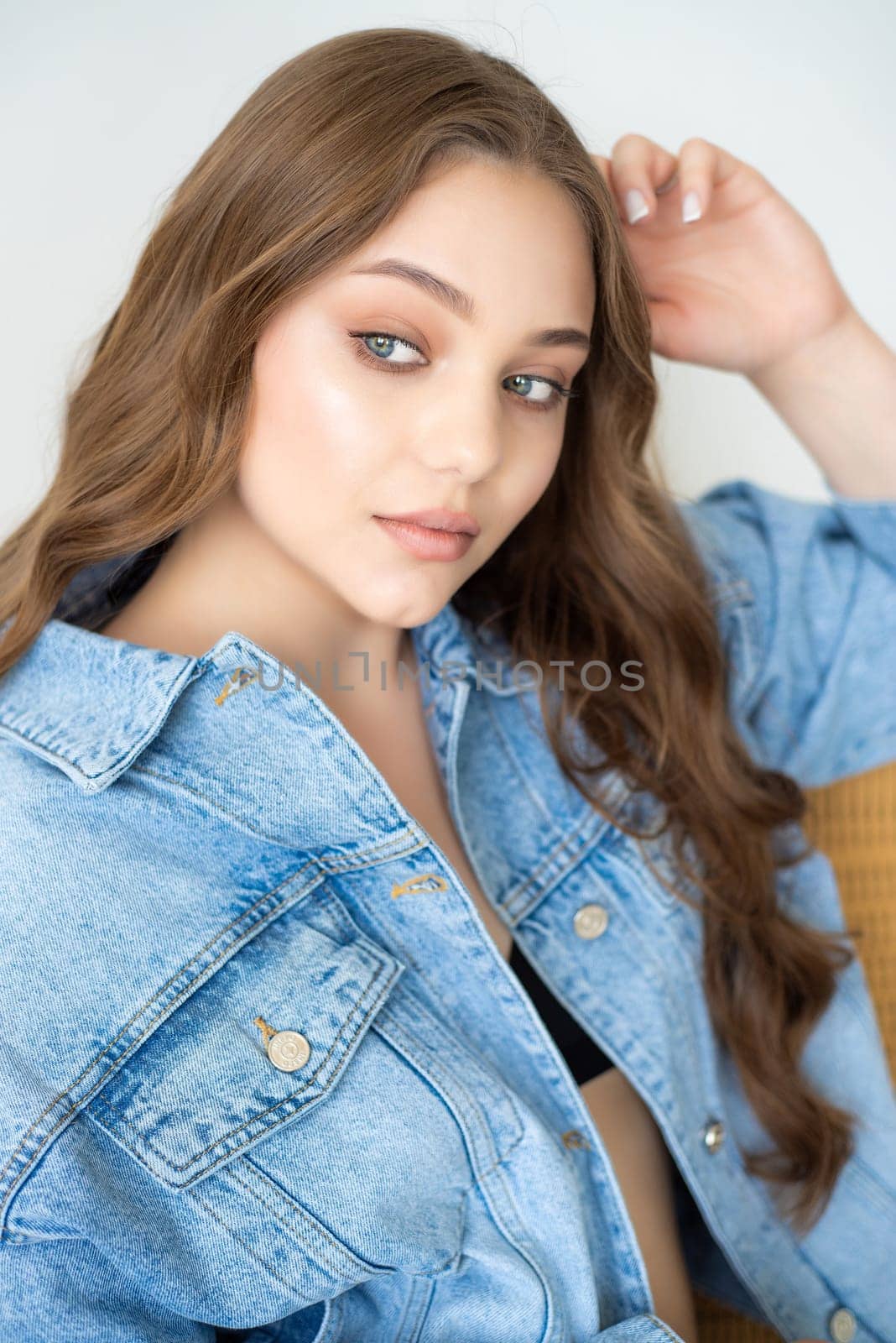 Woman in jeans jacket on studio background