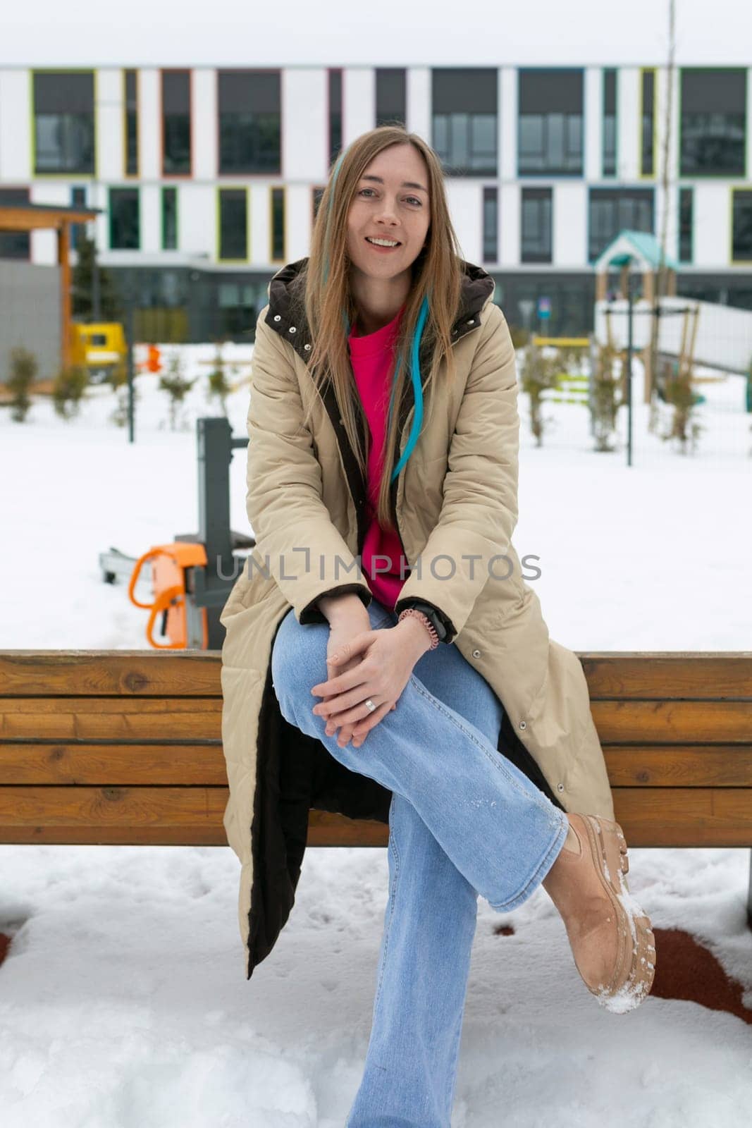 Woman Sitting on a Bench in the Snow by TRMK
