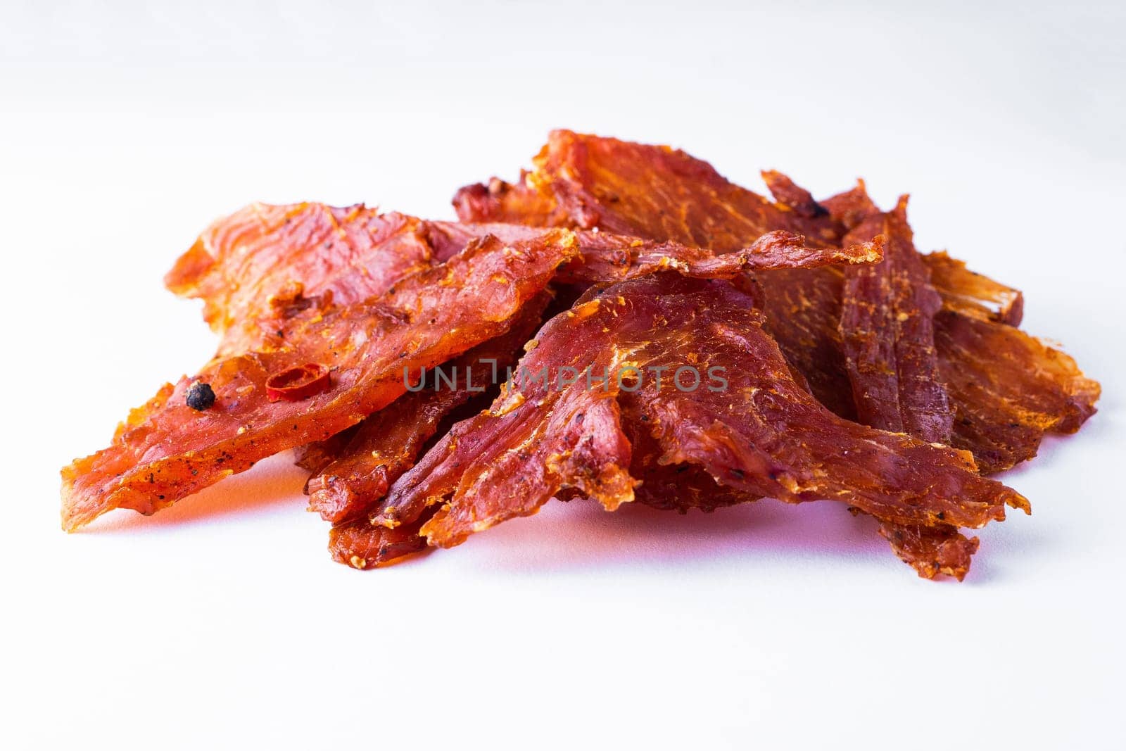 Beef jerky pieces isolated on white and black background