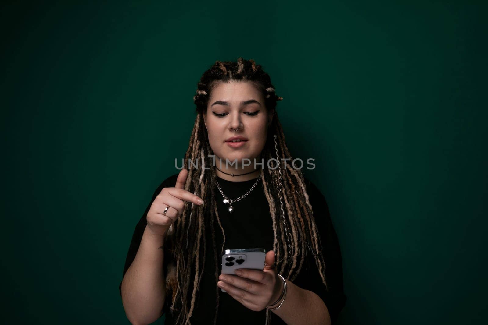 Woman With Dreadlocks Looking at Cell Phone by TRMK