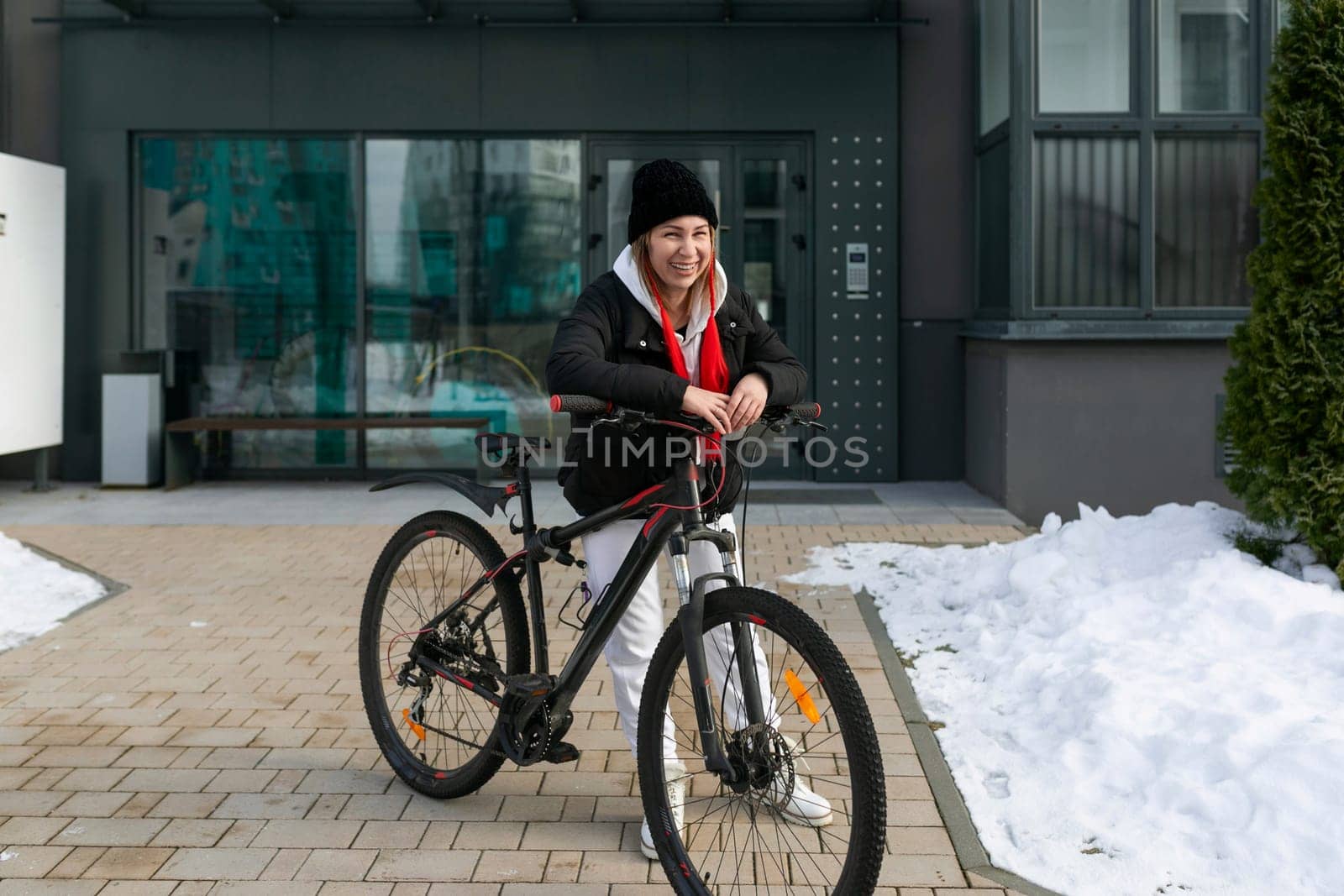 Lifestyle concept, Caucasian woman goes outside with a bicycle by TRMK