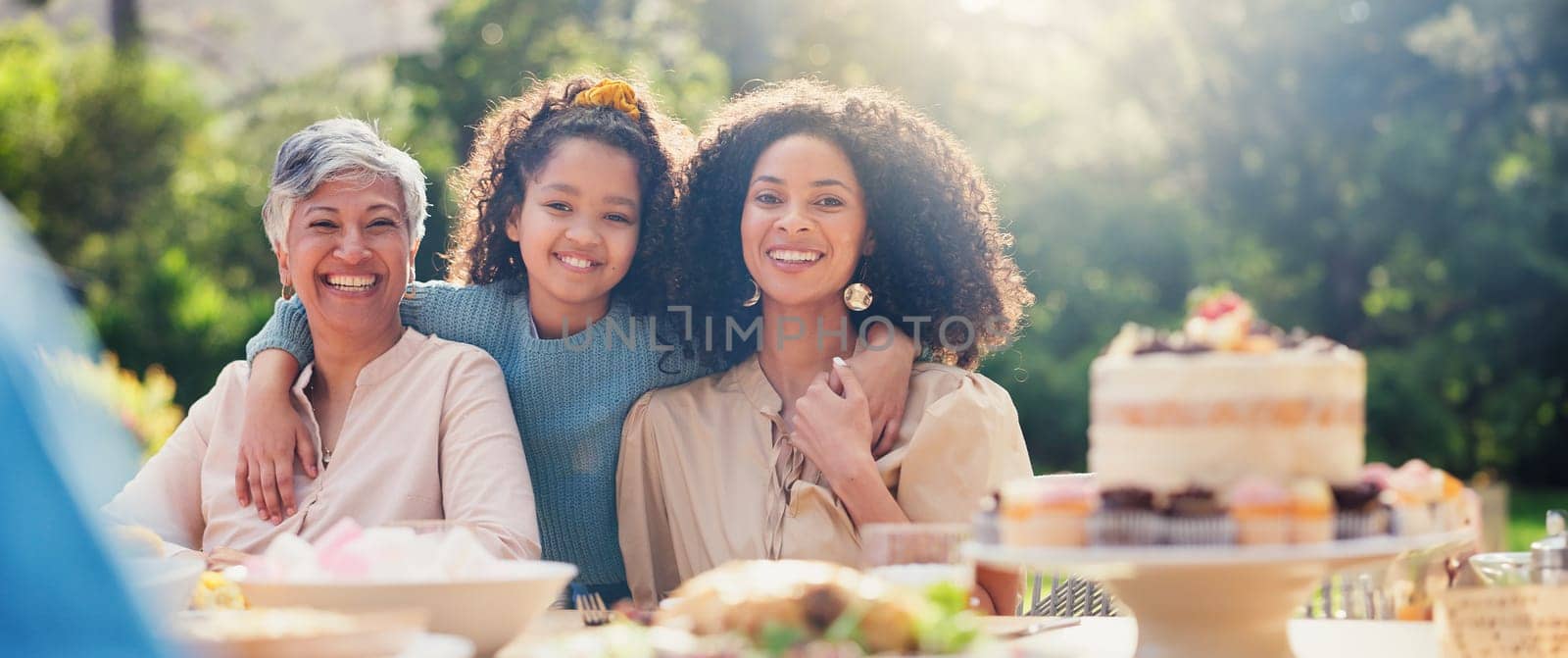 Family, hug and face at birthday party on table outdoor with mother, child and grandma with smile. Summer, event and celebration with love, support and girl in garden with generation of women or moth.