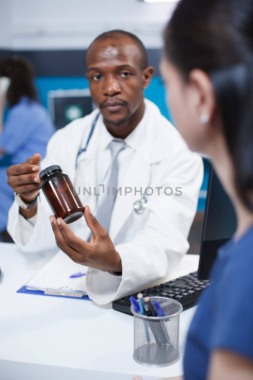 Doctor explaining the medicine to woman by DCStudio