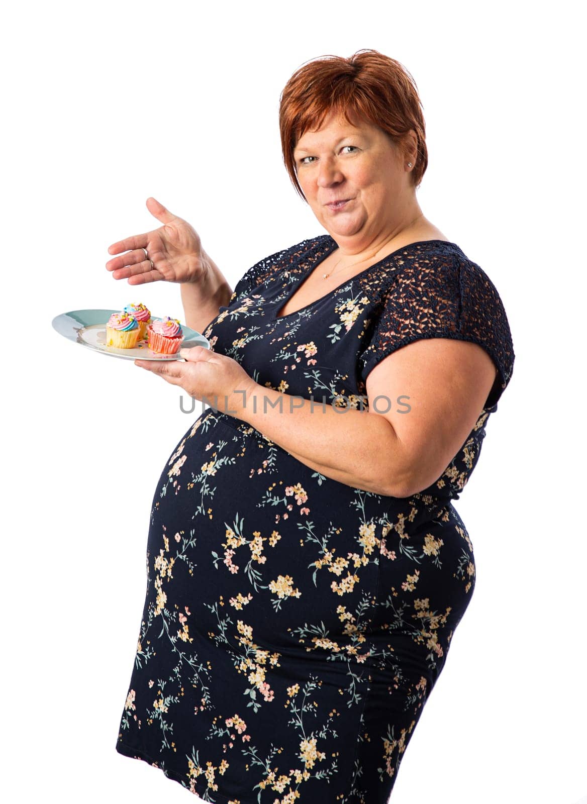 Fifty something woman a plate of cupcakes and presenting them