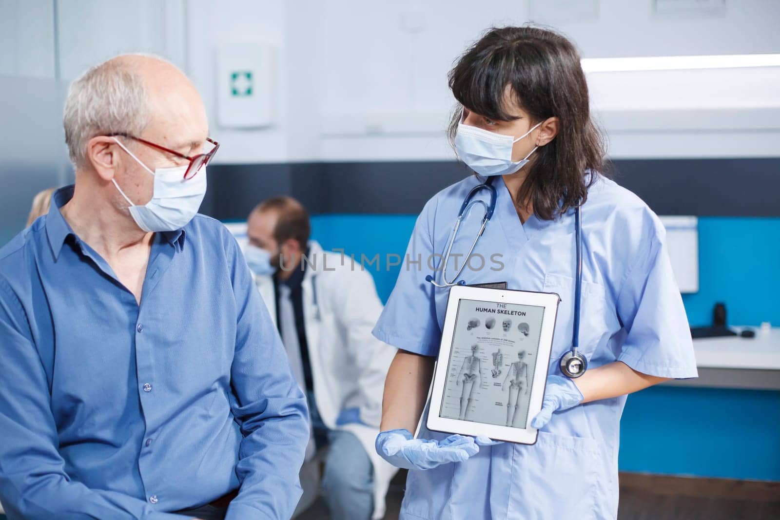 Nurse grasps device with human skeleton by DCStudio