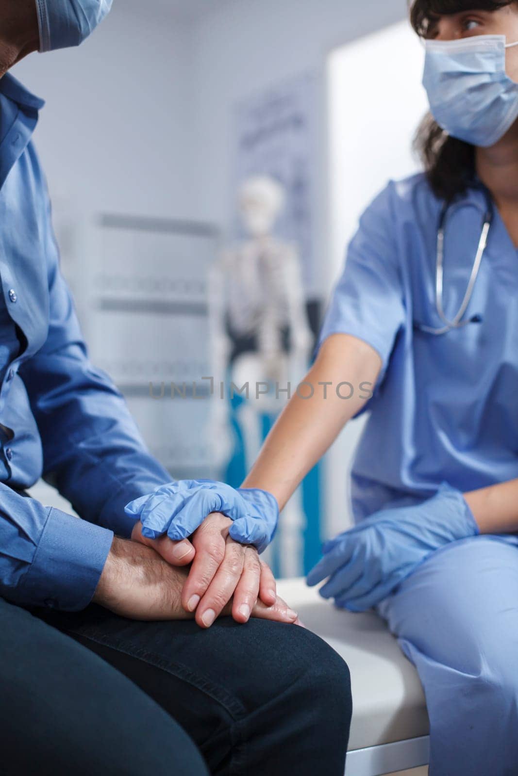 Medic assistant helping senior patient by DCStudio