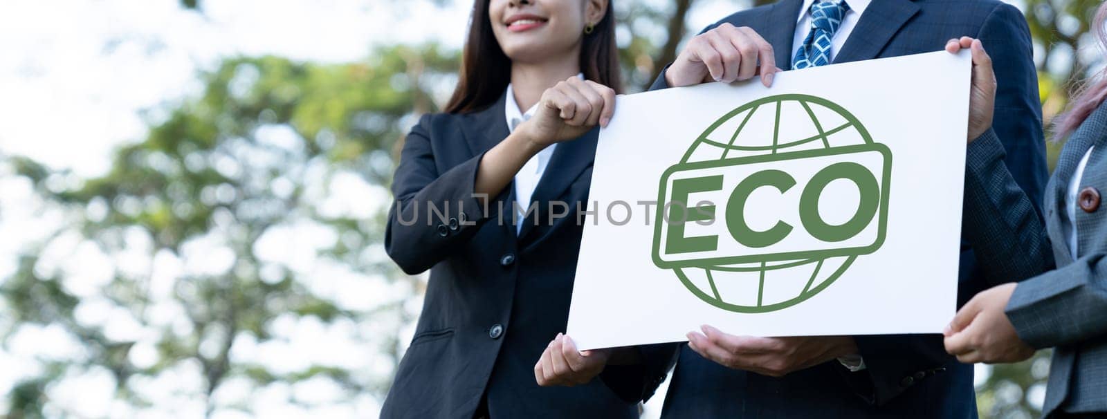 Group of business people stand united, holding eco-friendly idea. Gyre by biancoblue