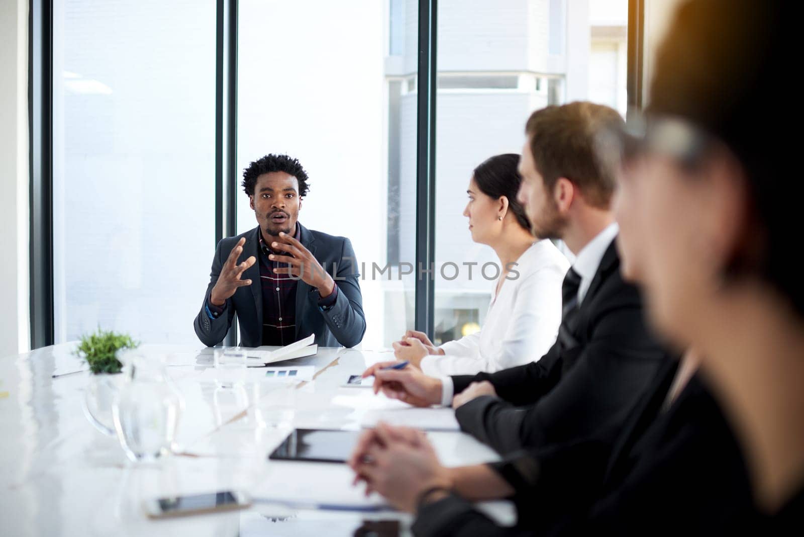 Meeting, discussion and leadership with business people in conference room with planning, strategy and teamwork. Boardroom, men and women at table for review, feedback or workshop at startup office.