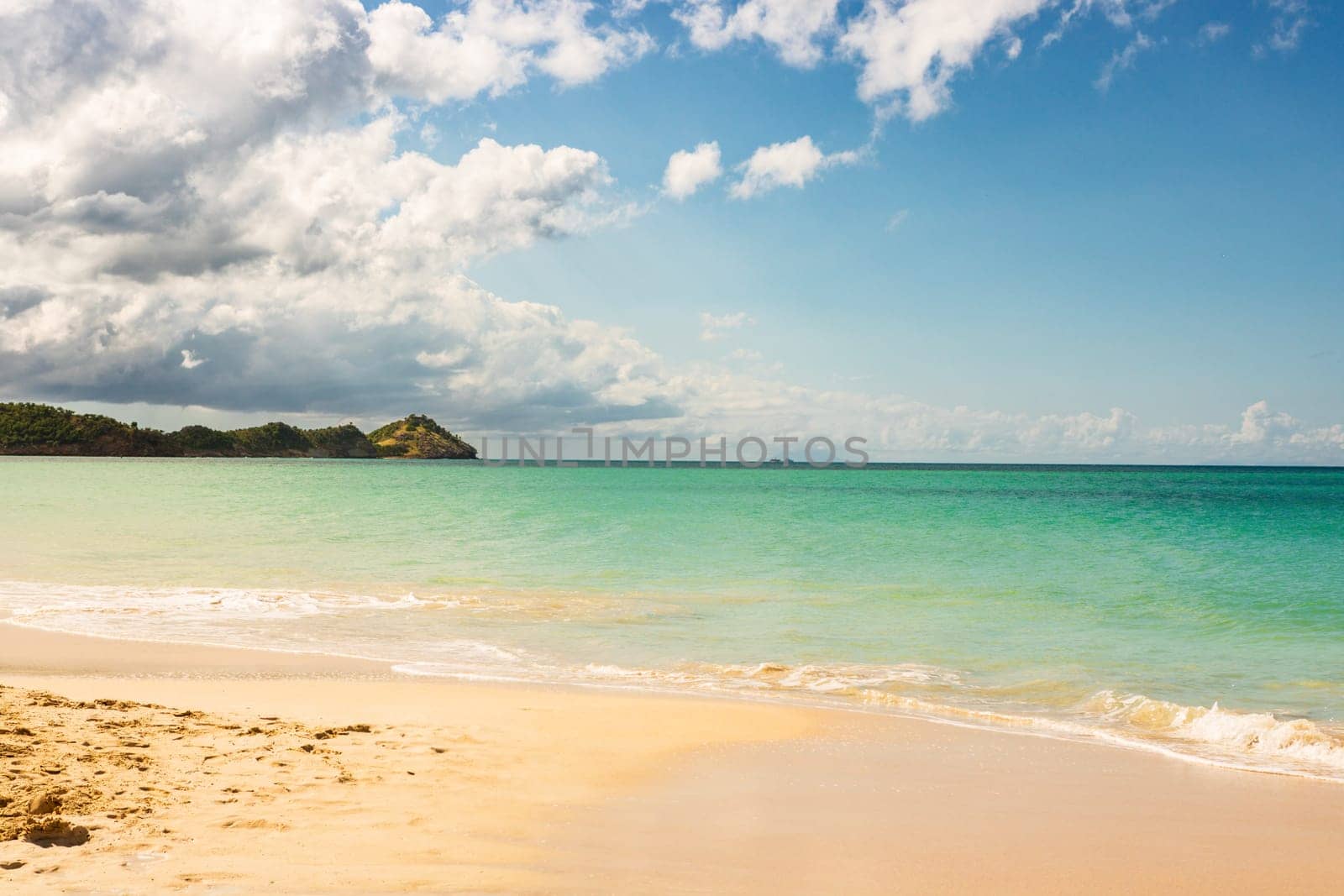 Caribbean beach with white sand, deep blue sky and turquoise water