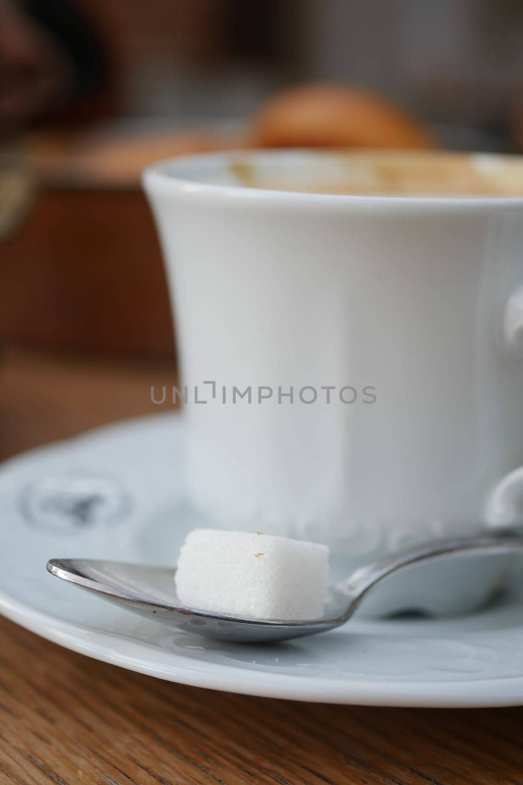 cup of tea and sugar cube on table by towfiq007