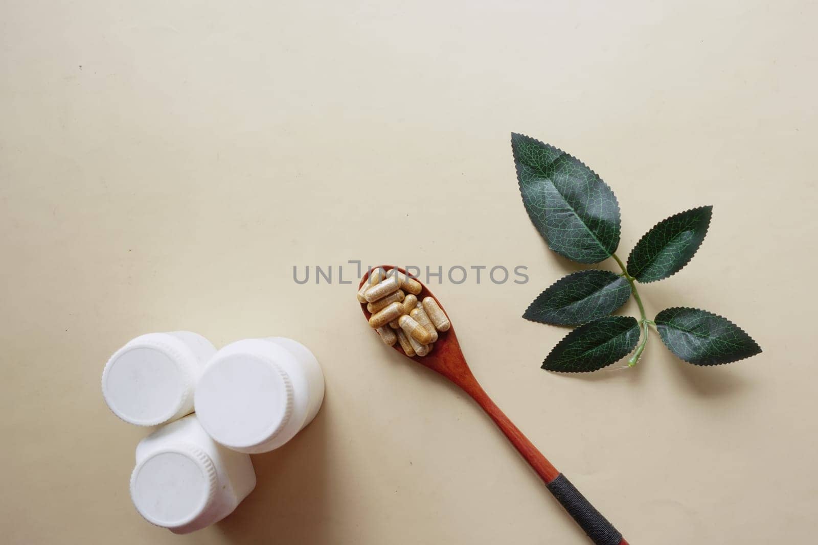 top view of herbal medicine capsule on wooden spoon ,