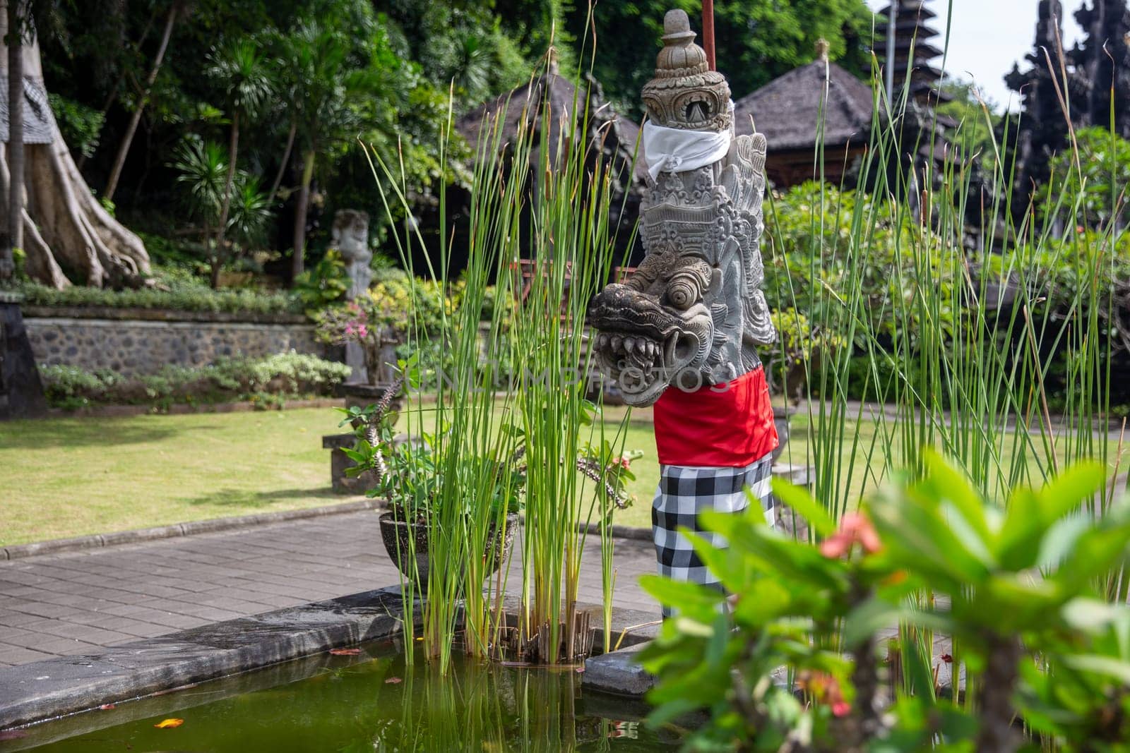Indonesian Deity Statue in a garden by a pond