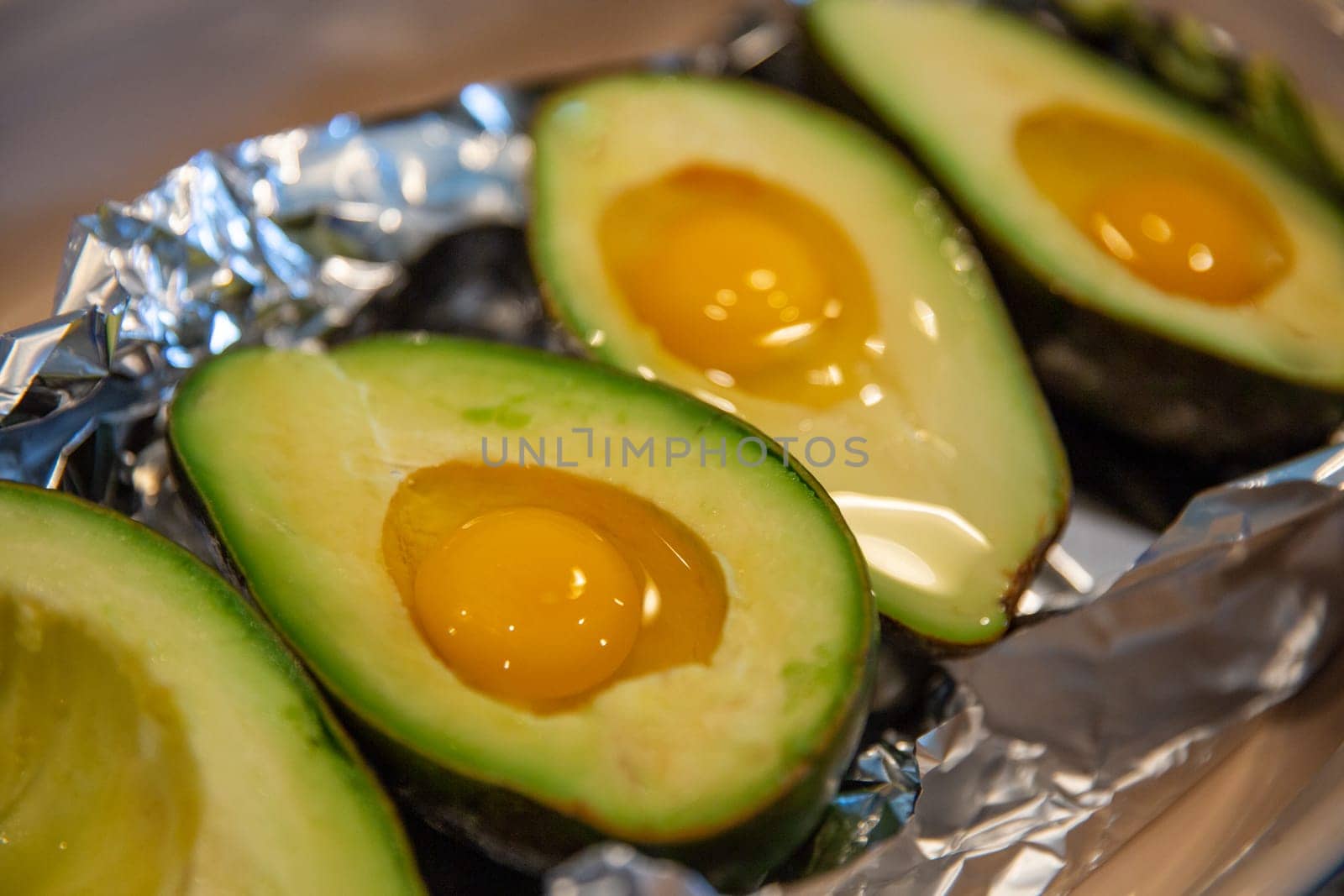Avocados with a raw egg yolk about to be baked