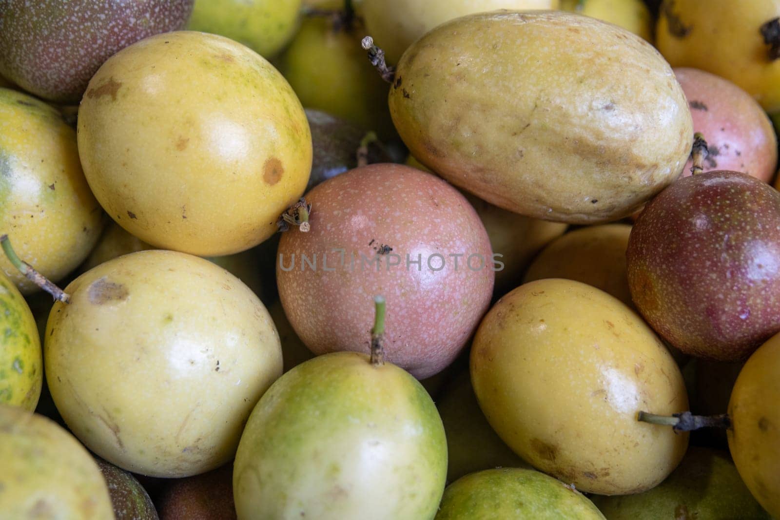 Passionfruit sliced on display on a grocery rack