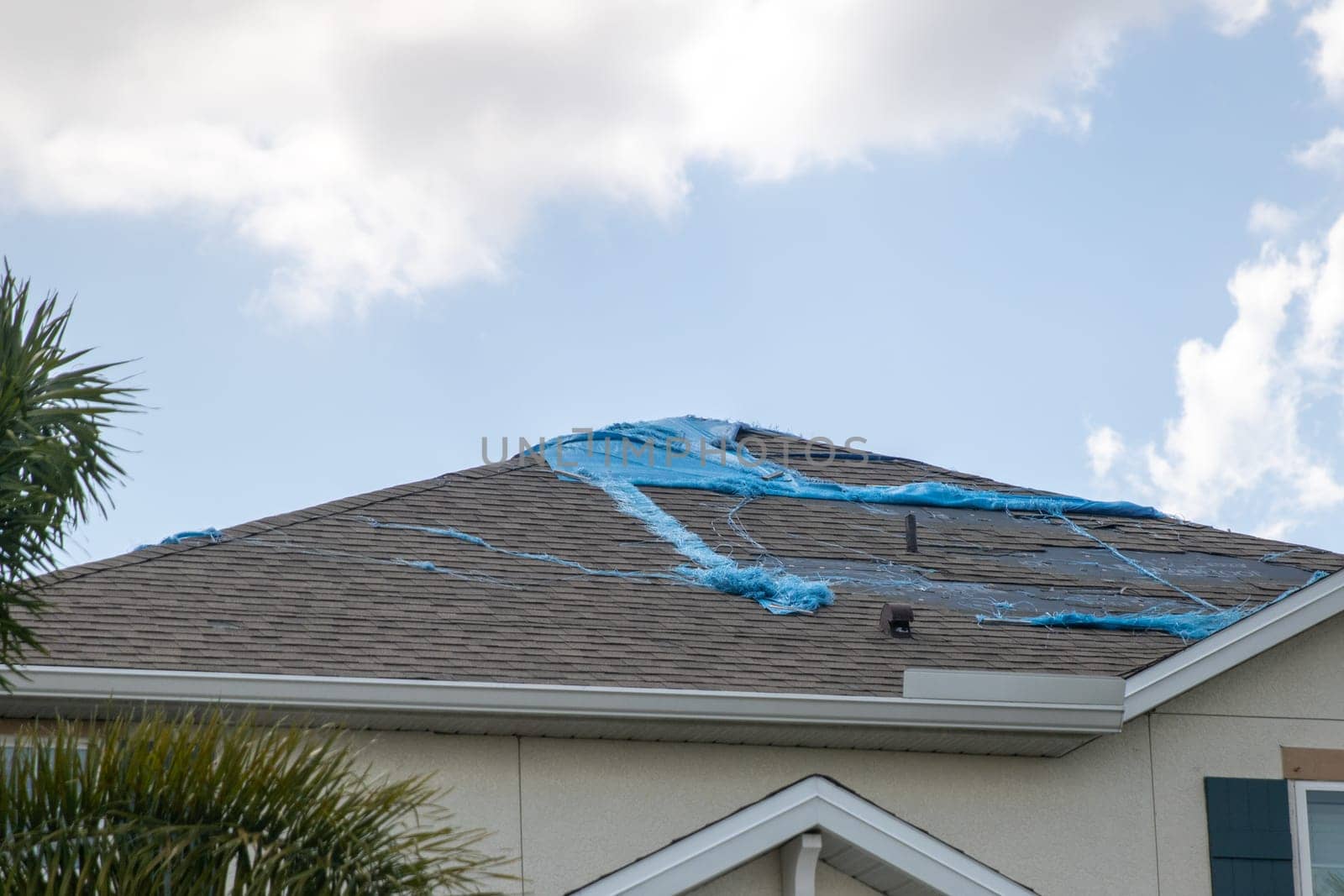 Destroyed Tarp on the roof waiting to get repaired