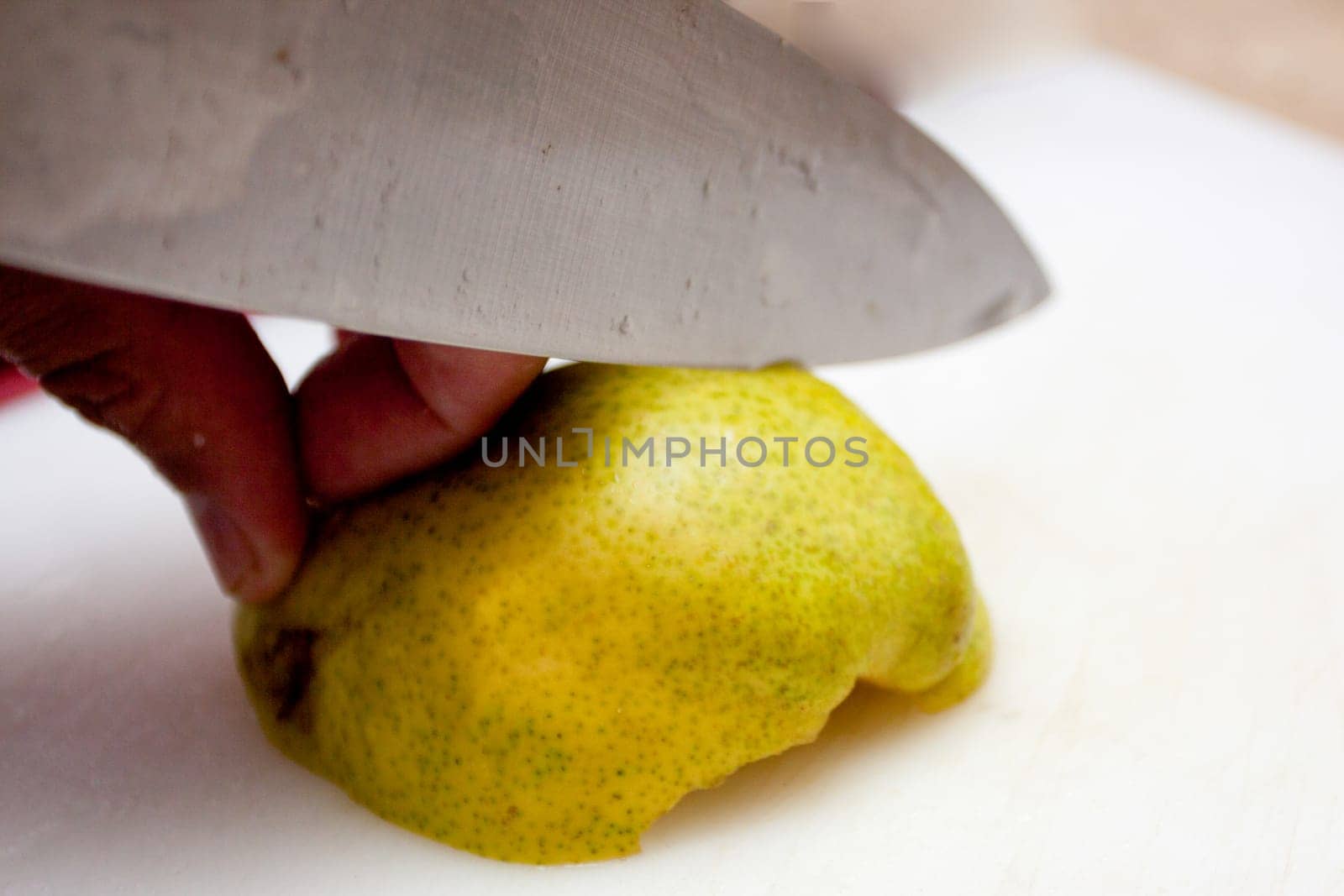 Slicing a pear with a knife shot very close