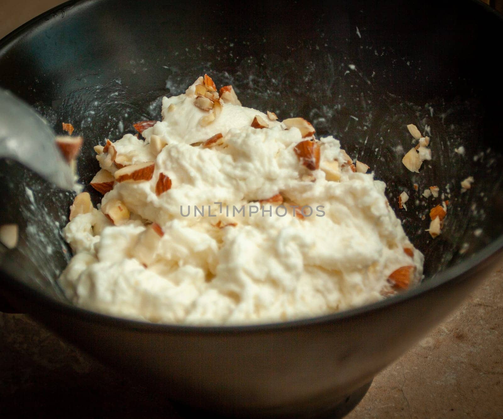 Sprinkling Almonds on Fresh Burrata to be an appetizer