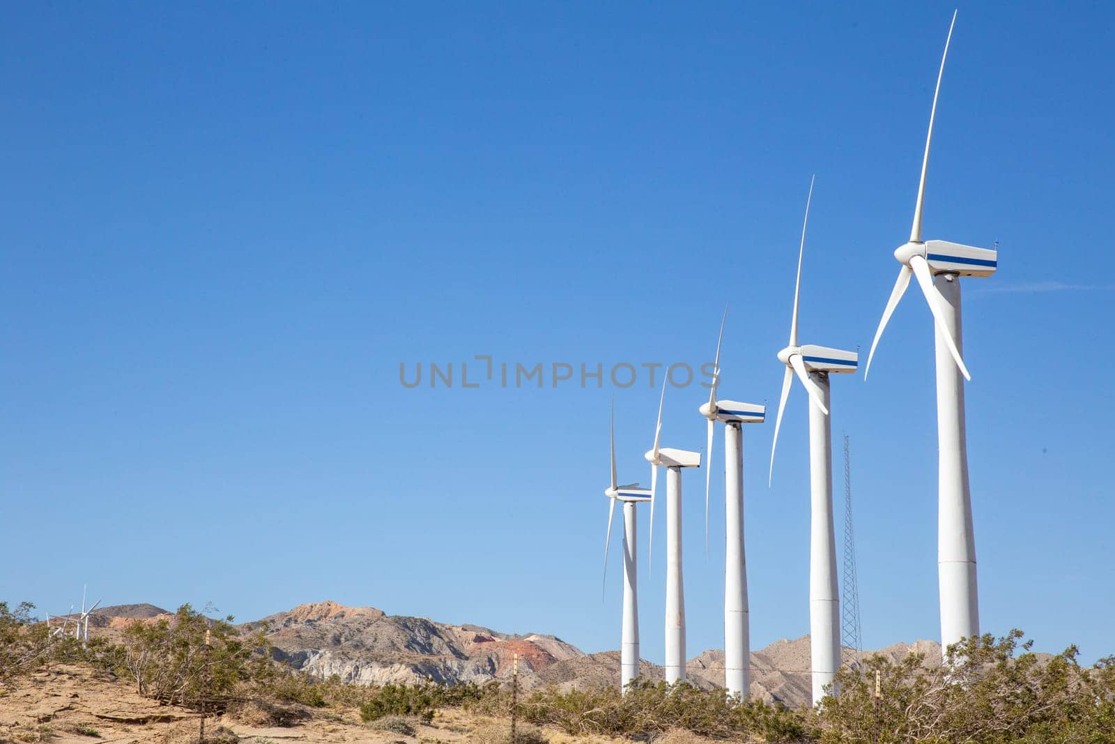Row of wind turbines in the desert