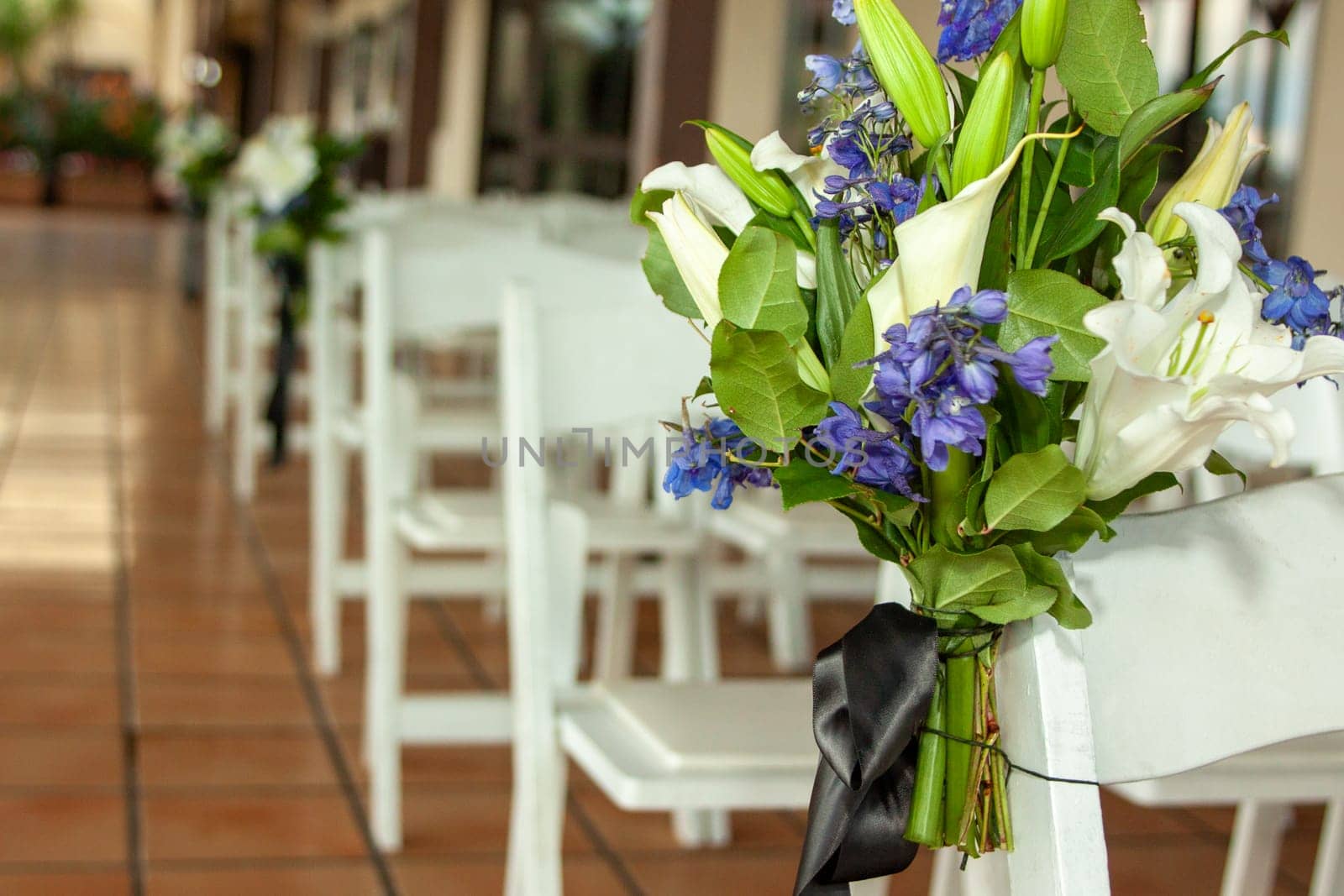 Floral designs of wedding aisle to show the area is ready