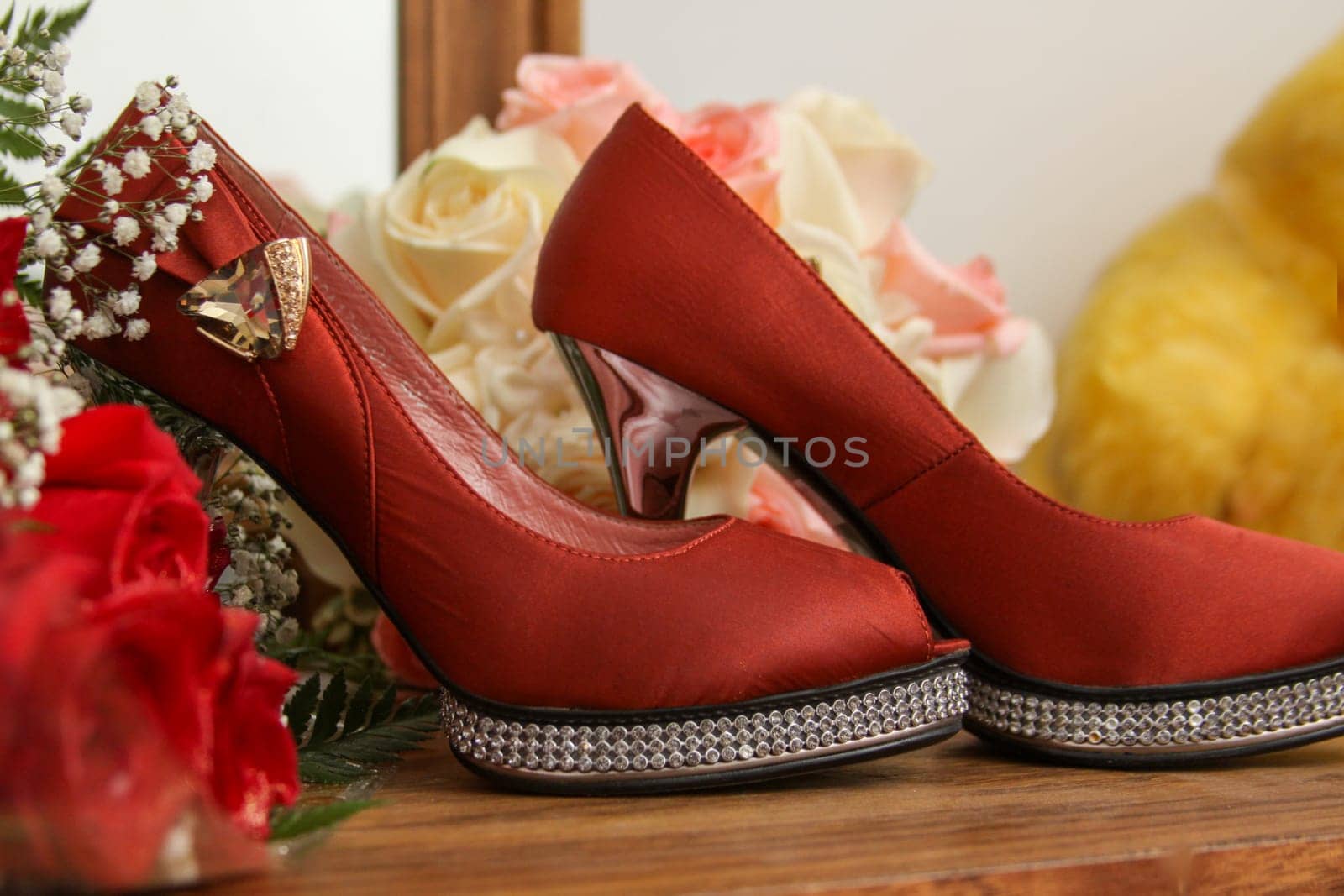 Red heels and bouquet for a wedding