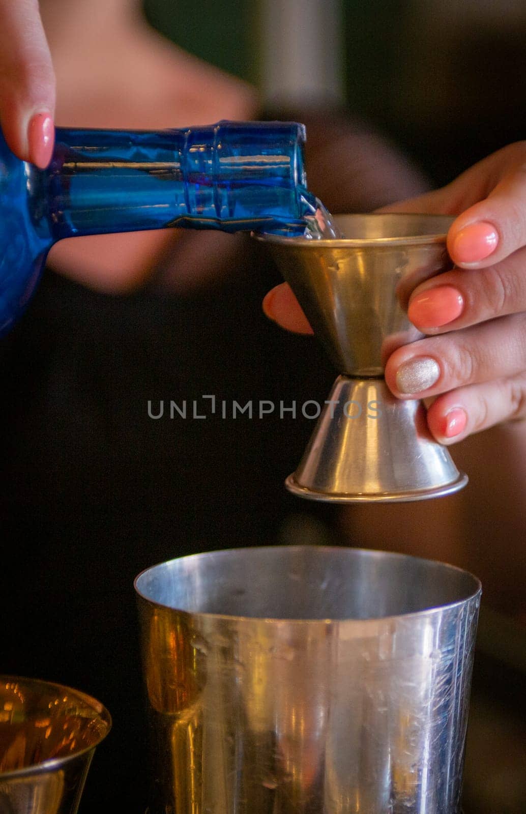 Pouring a shot to be mixed and served