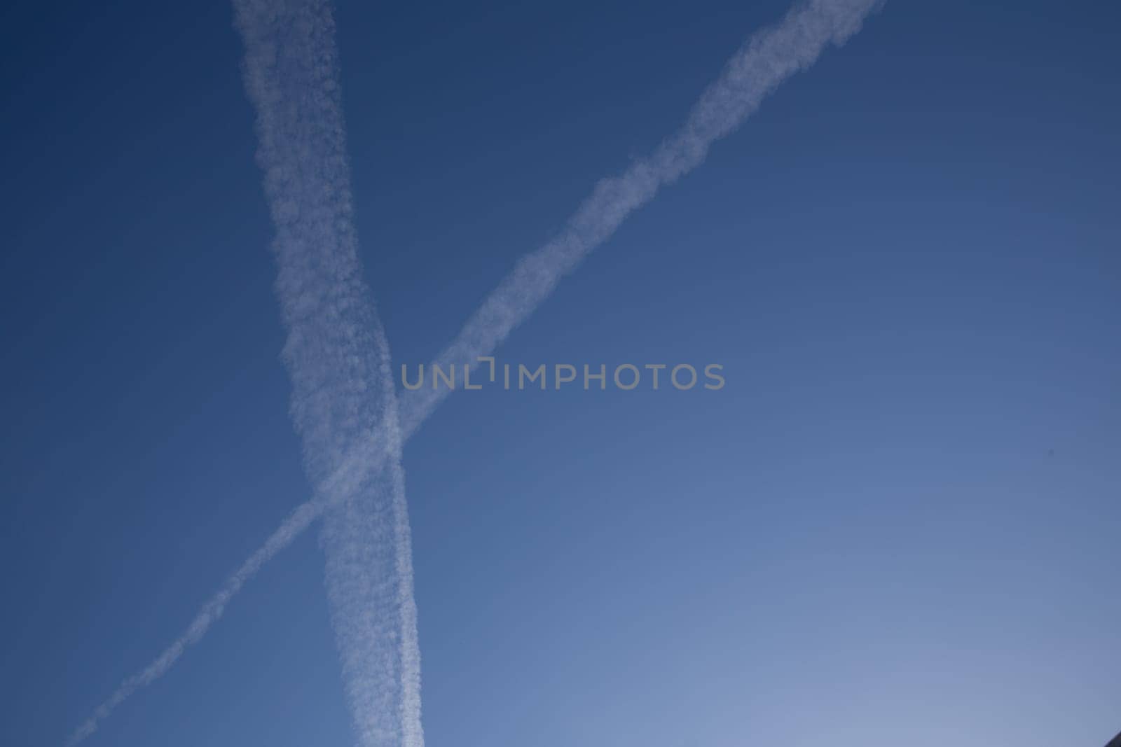 Chemical trails in the sky making an X