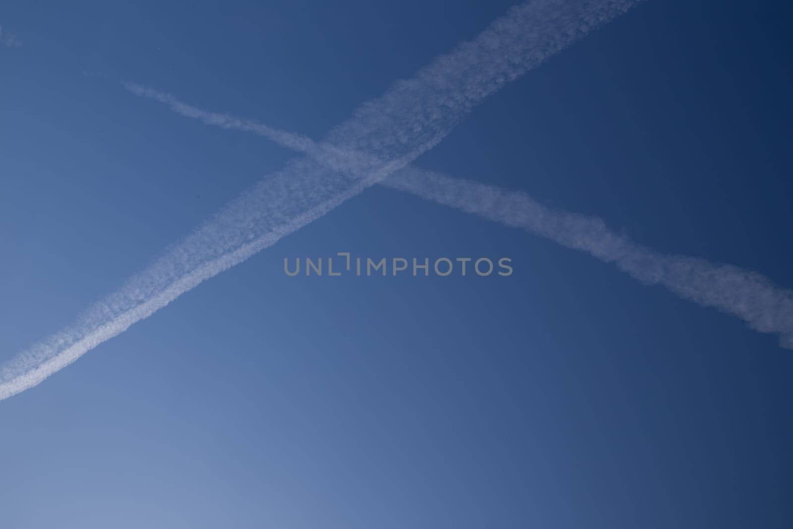 Chemical trails in the sky making an X