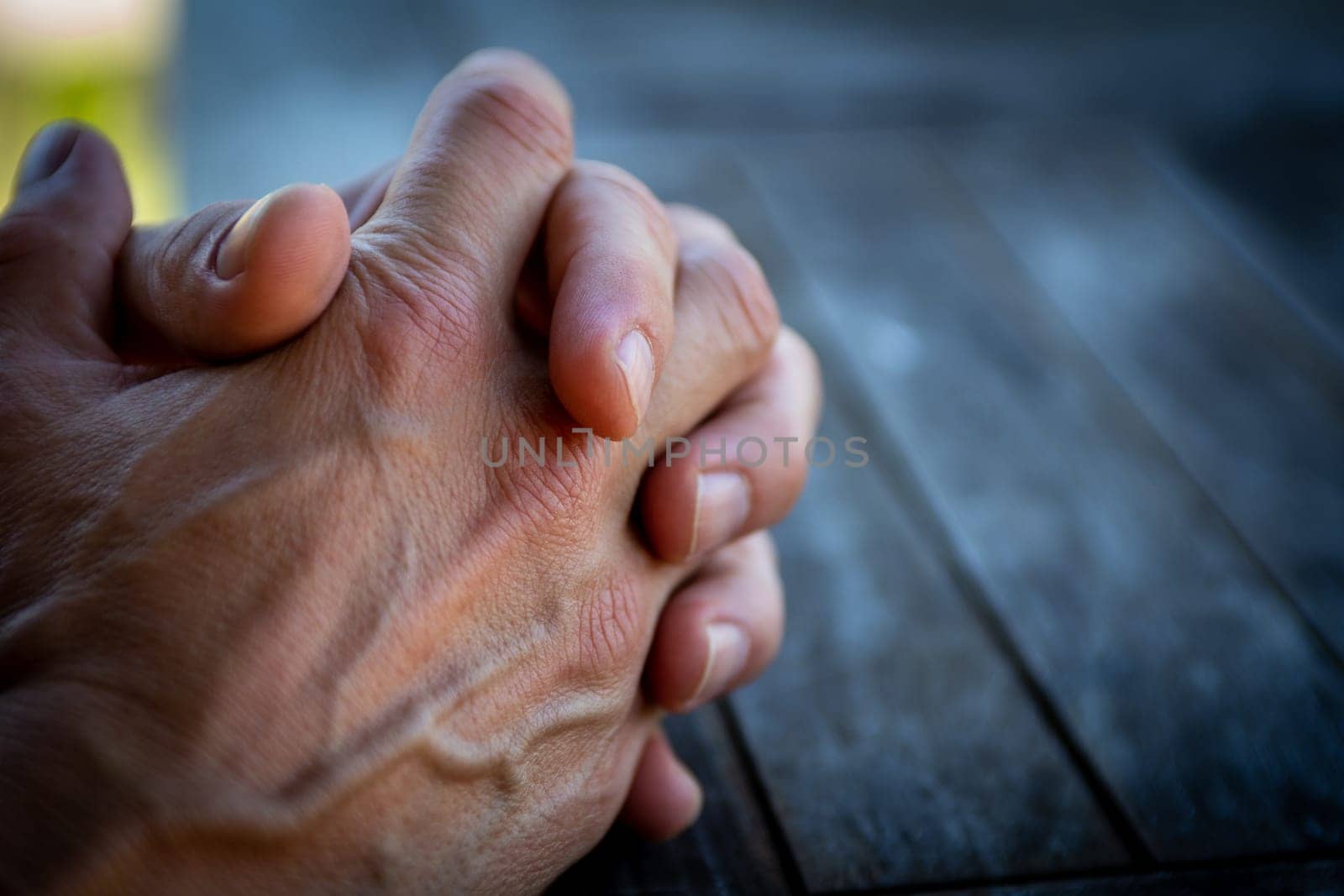 Mans hands together waiting to be taken cared of