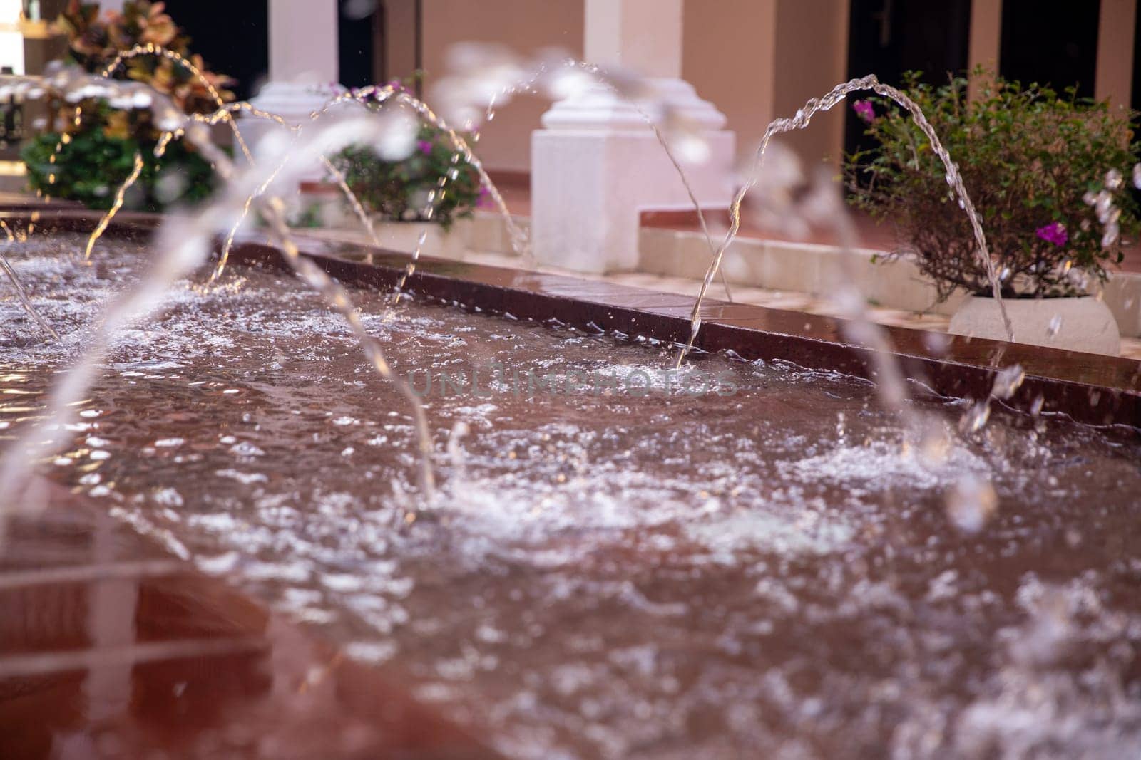 Mini water fountains on display in a courtyard