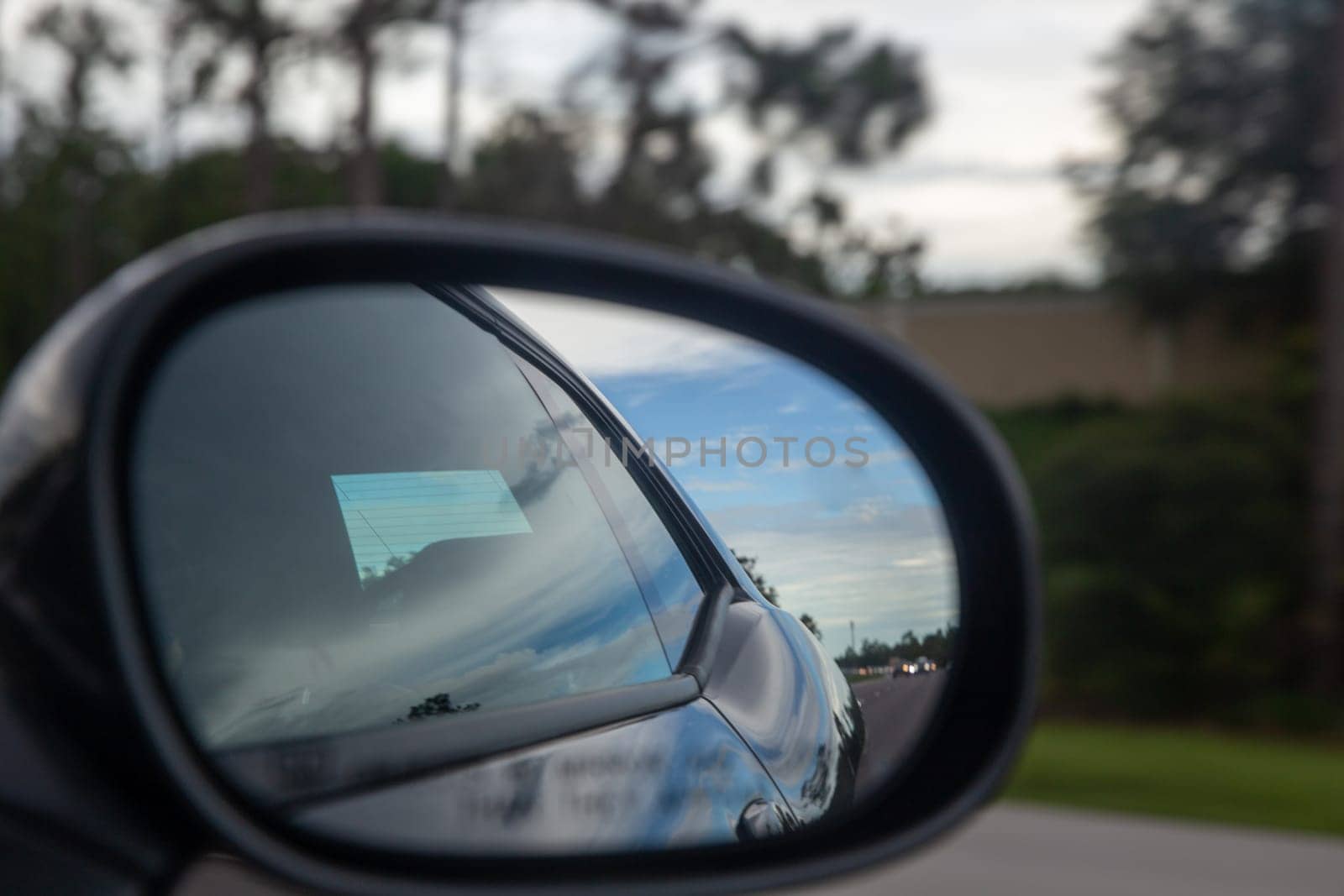 Speeding Car through a rear view mirror driving