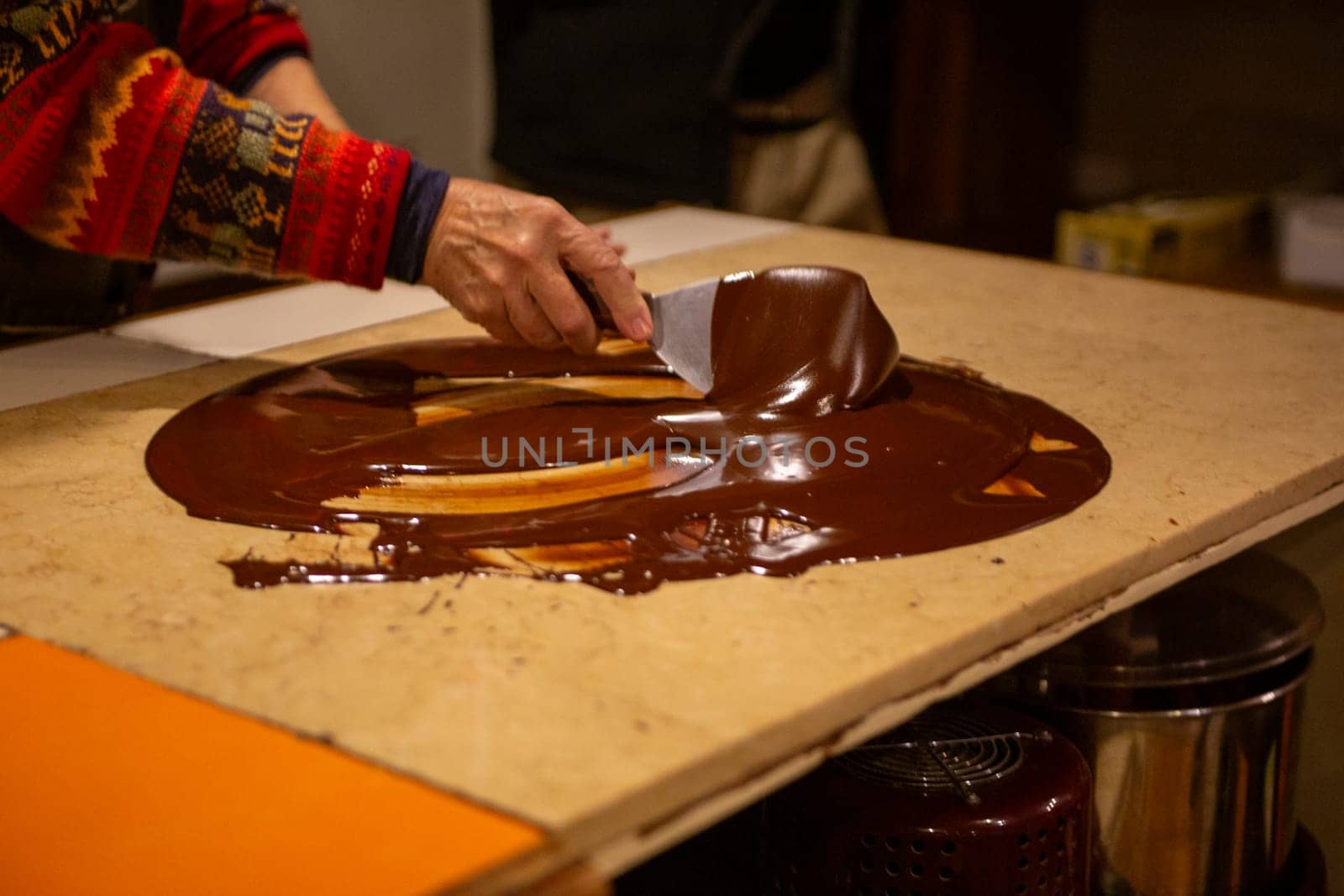 Chocolatier spreading chocolate as a demonstration