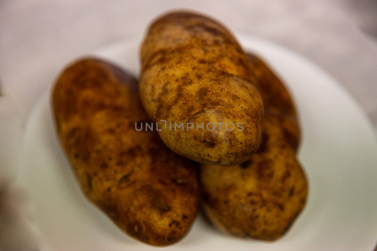 Three Russet Potatoes ready to be baked