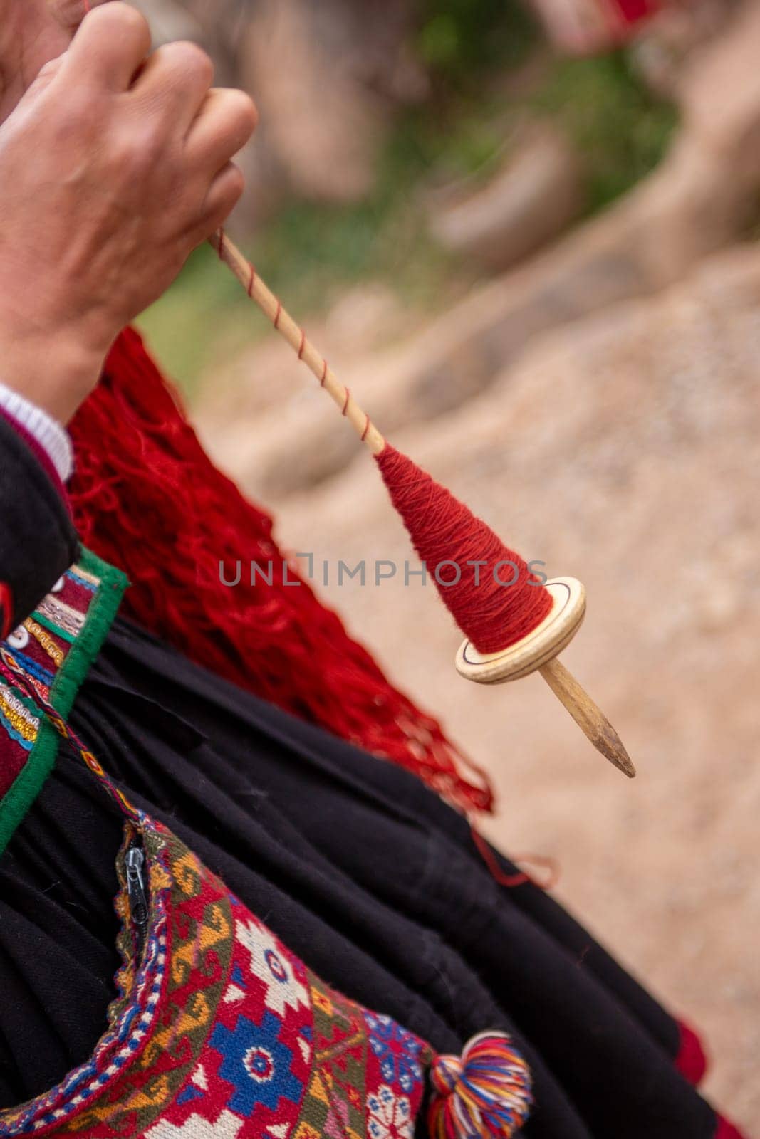 Spool of Red Dyed Wool demonstration by a Peruvian Woman