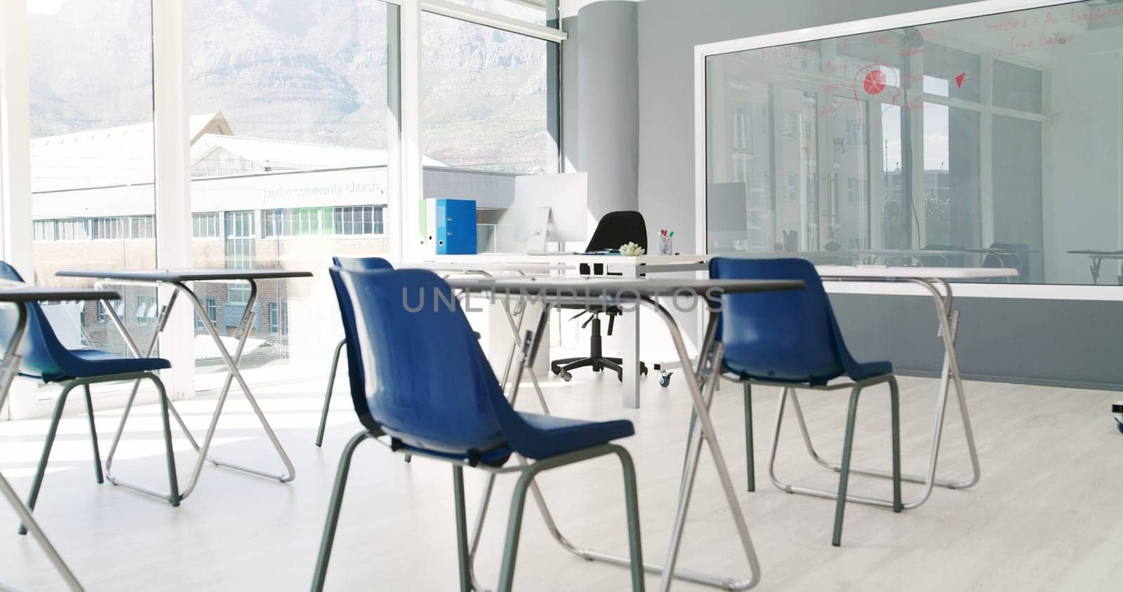 Empty, classroom and clean furniture with board for exam, test or setup of chairs, desks or interior. Indoor venue, layout or preparation of space for study, lesson or row with seats in arrangement by YuriArcurs