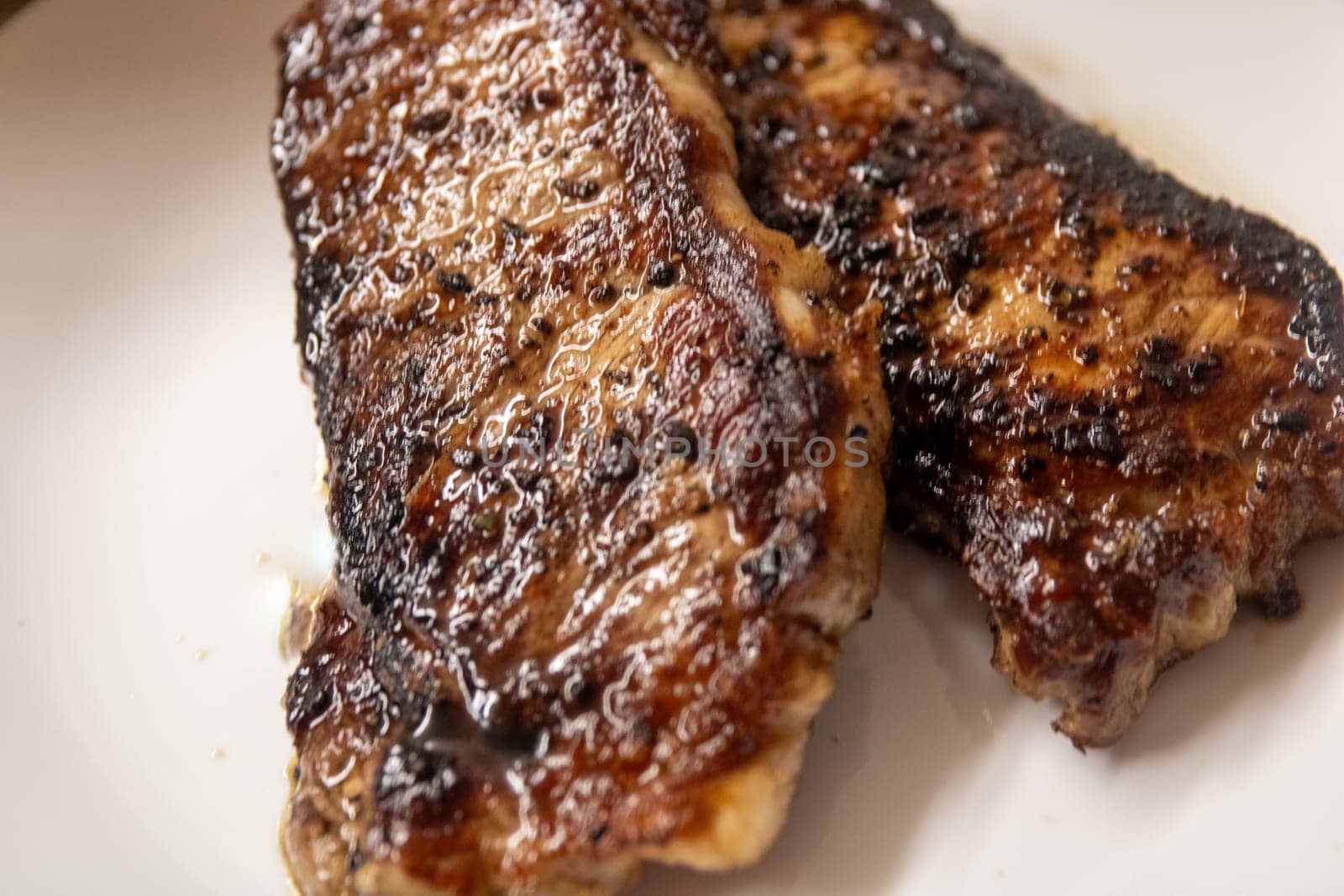 Two new York strips resting on a board