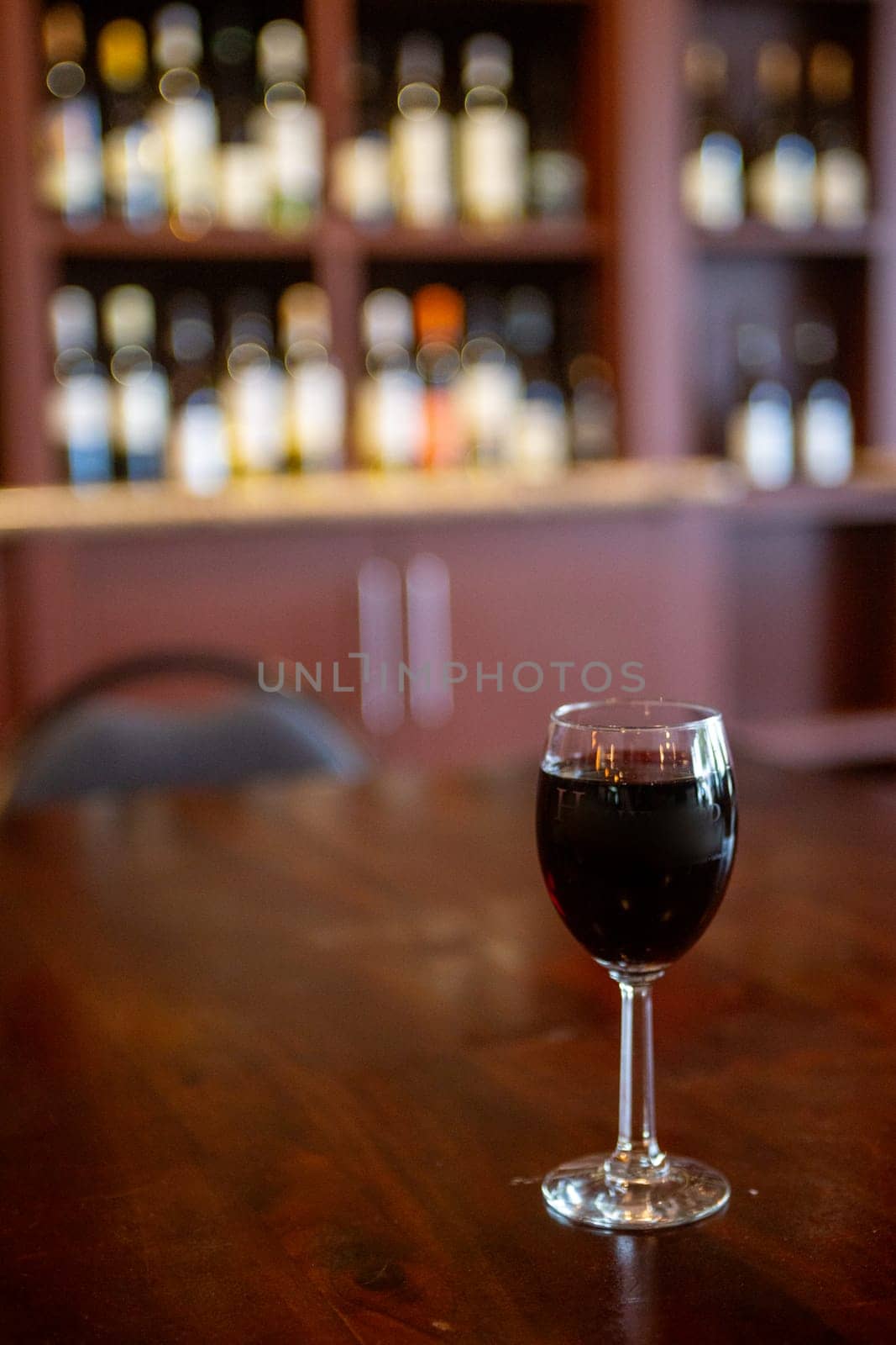Glass of red wine on a bar
